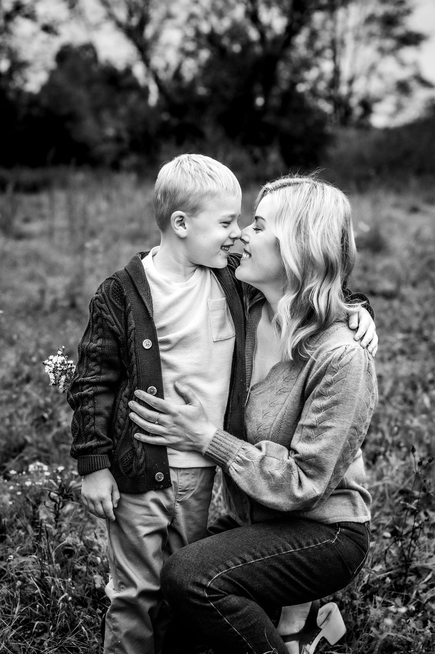Black and white photo series showing tender moments shared between a parent and child in a wildflower meadow, near Milwaukee, WI
