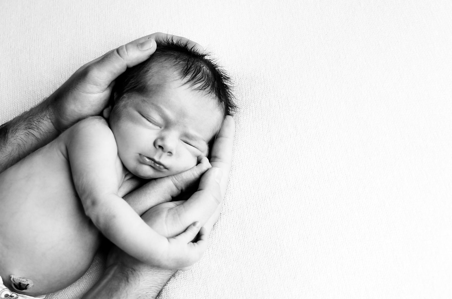 Black and white artistic photo series showing a sleeping baby in different peaceful poses against a light background. Kewaskum, WI