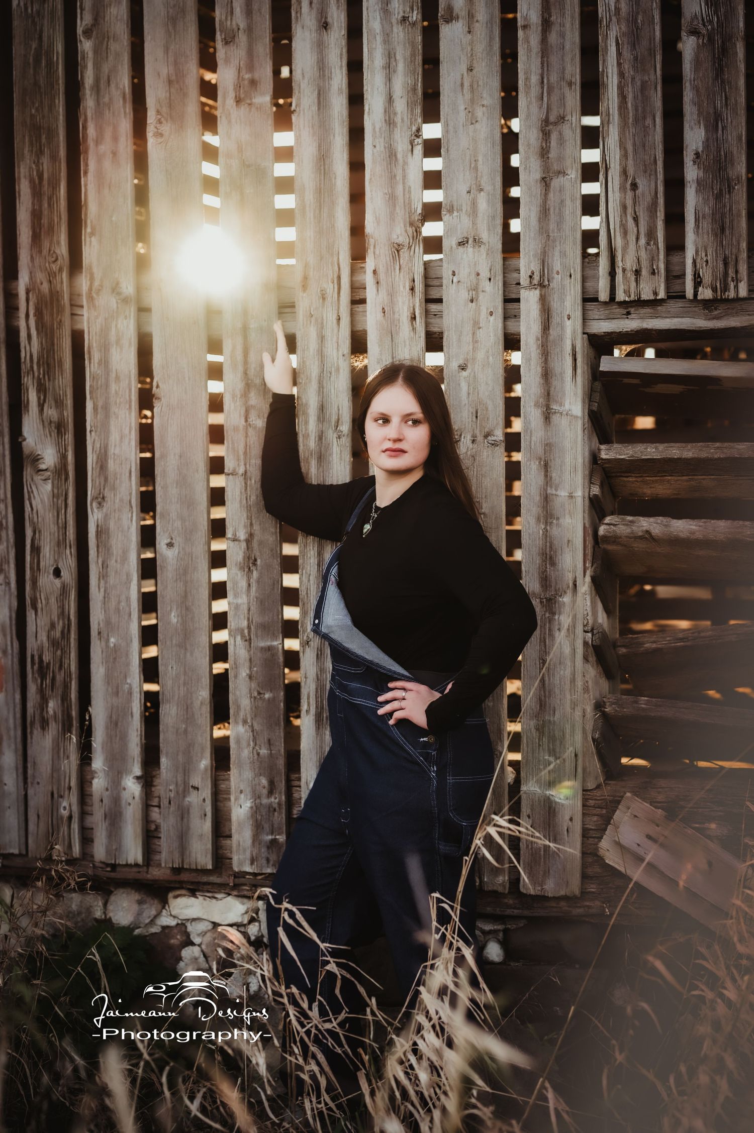 Rustic photo shoot with sunlight streaming through weathered wooden barn slats.
