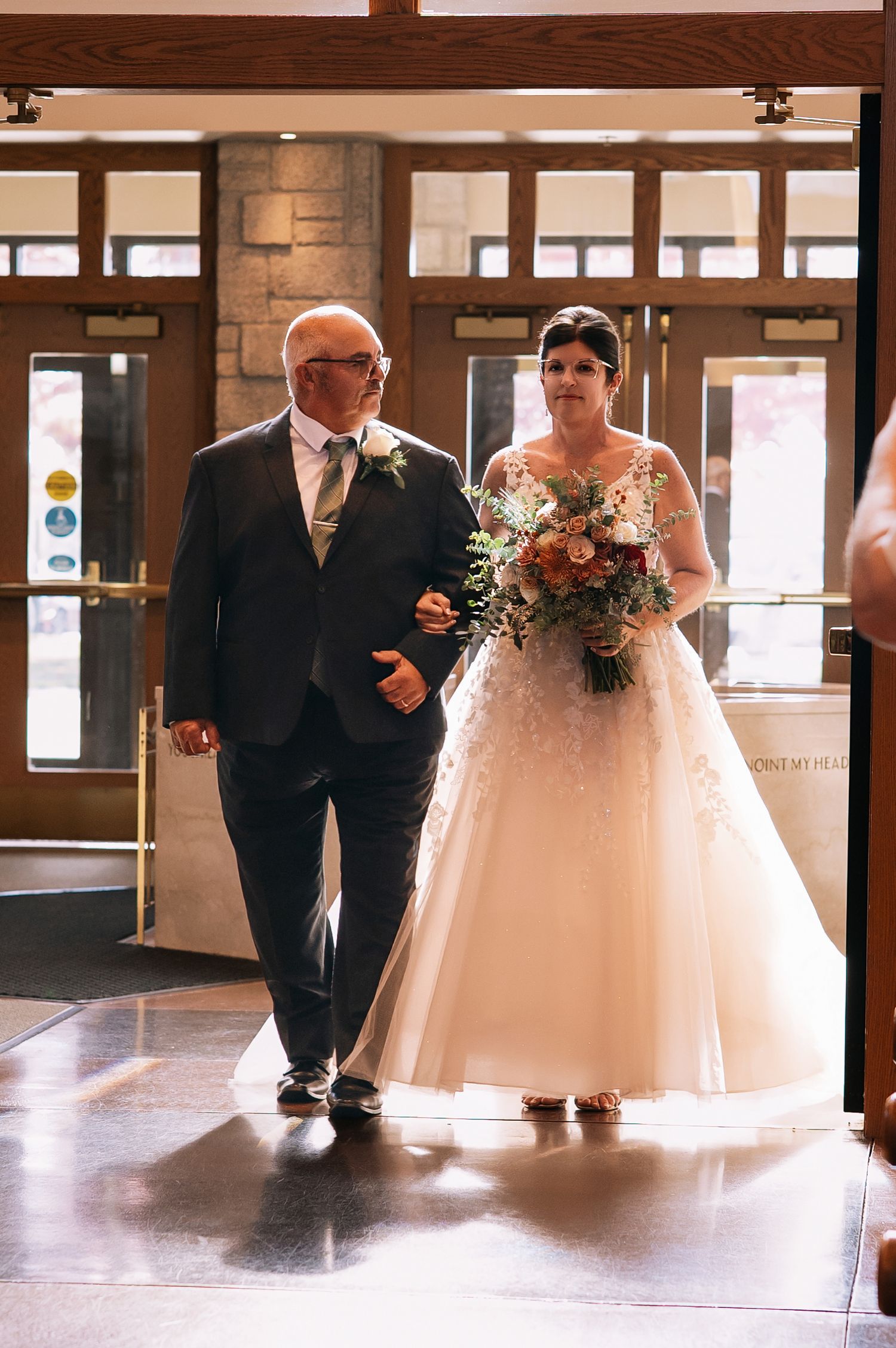 A sequence of wedding photos showing a bride in a white gown and groom walking down a hallway with brick walls.