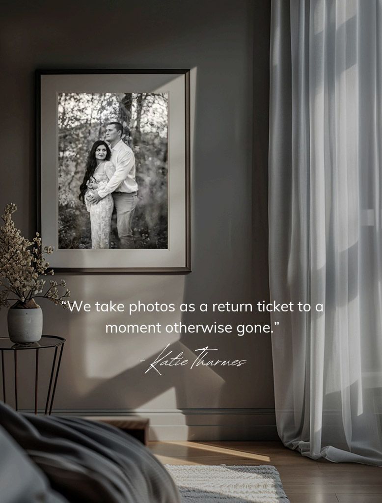 Framed black and white couple portrait on bedroom wall with Katie Tharnes photography quote about capturing memories.