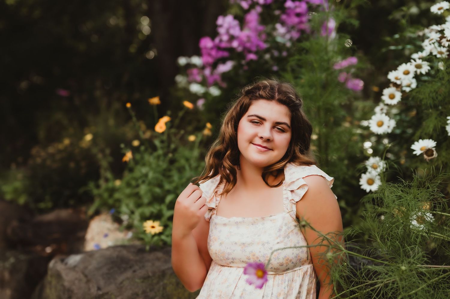 Natural portrait in a flower garden with pink and white blooms during sunset.