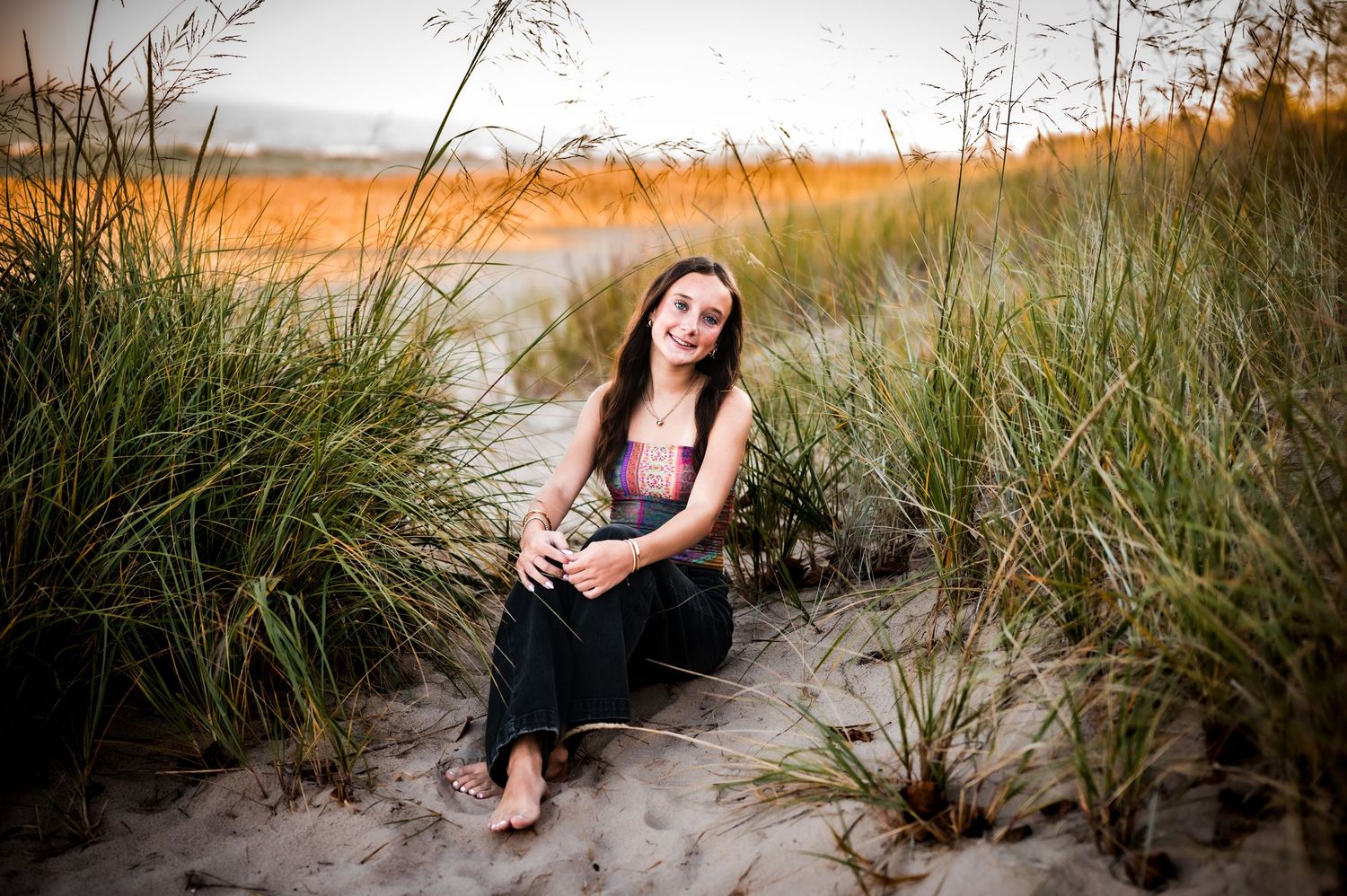 A collection of sunset beach photos showing someone posing on sandy shores during golden hour.