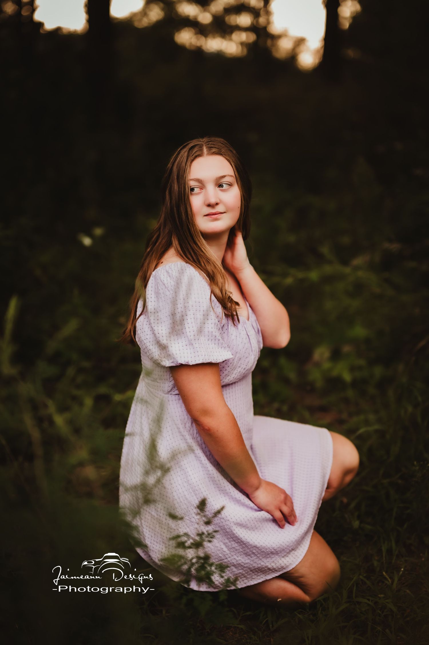 Soft lighting creates a dreamy atmosphere in this outdoor portrait with a white eyelet dress.