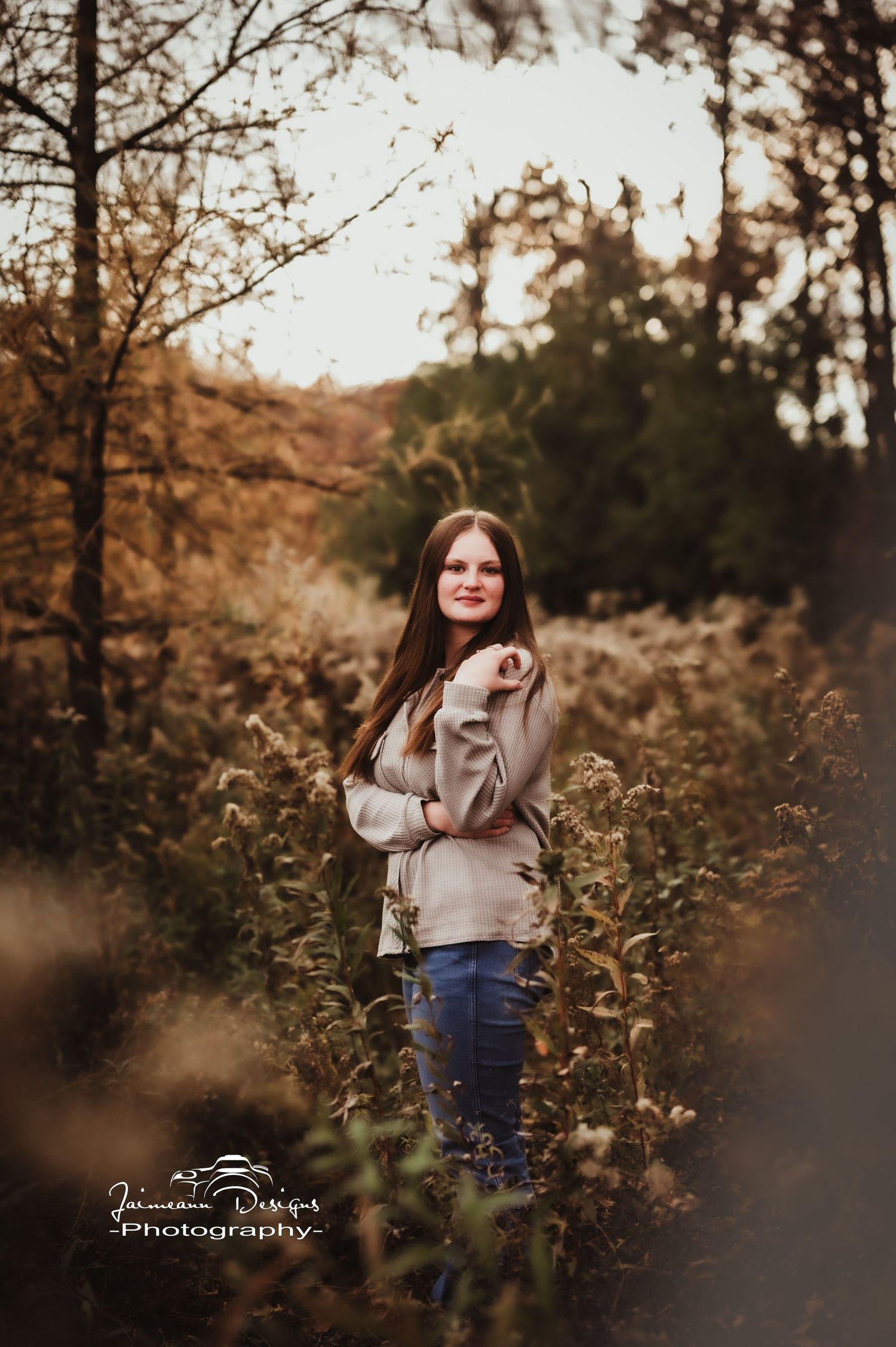 Fall season portrait surrounded by golden foliage and natural lighting.