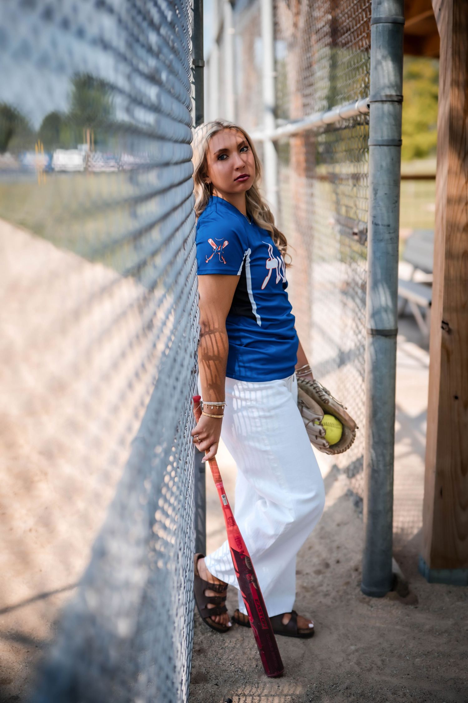 Senior softball portrait in the dugout at the Fillmore ball diamond in Southeast Wisconsin