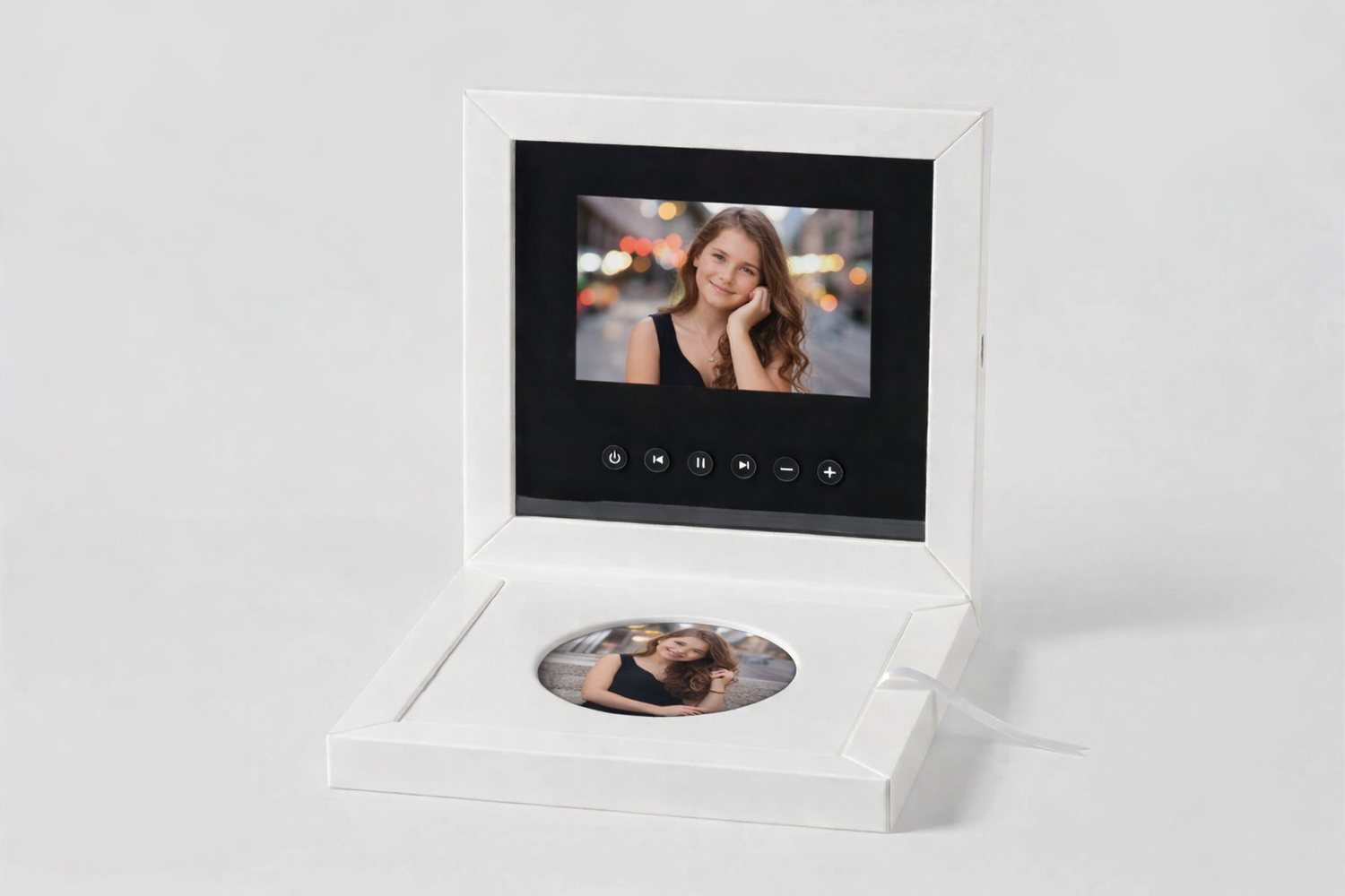 White digital photo frame box open displaying a woman's portrait on screen with a DVD disc inside.