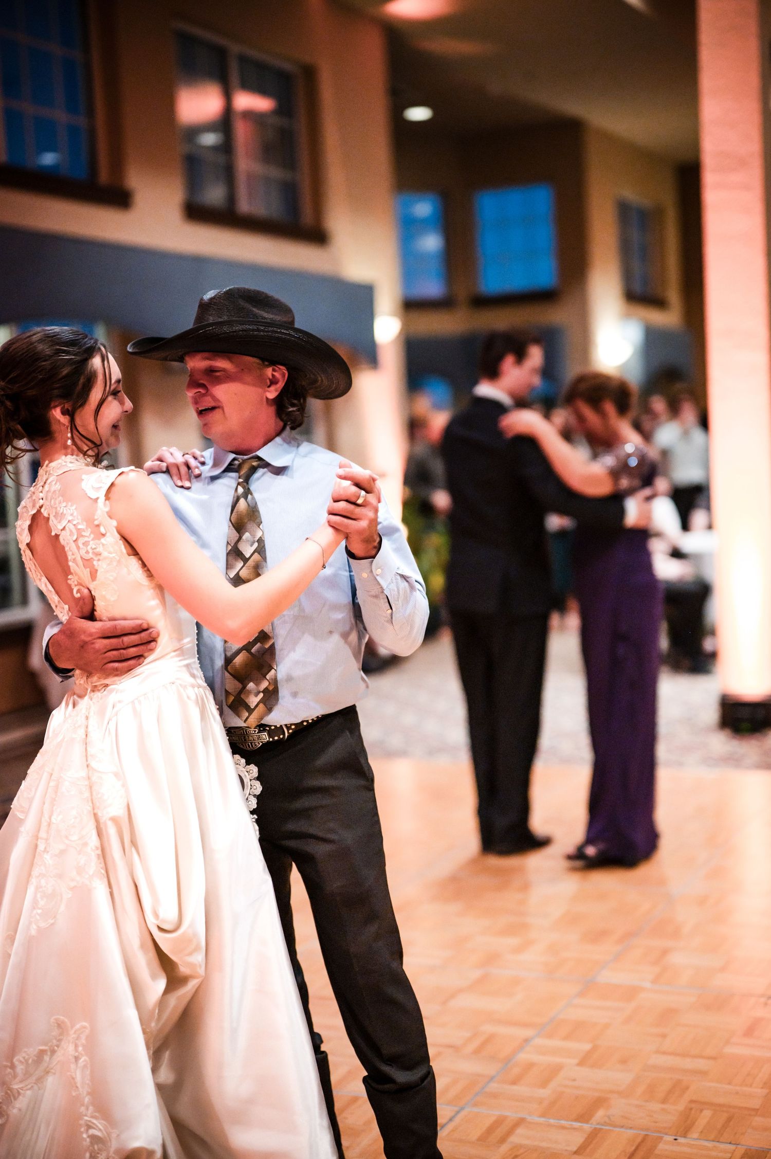 Wedding reception dance floor with couples dancing in formal attire.