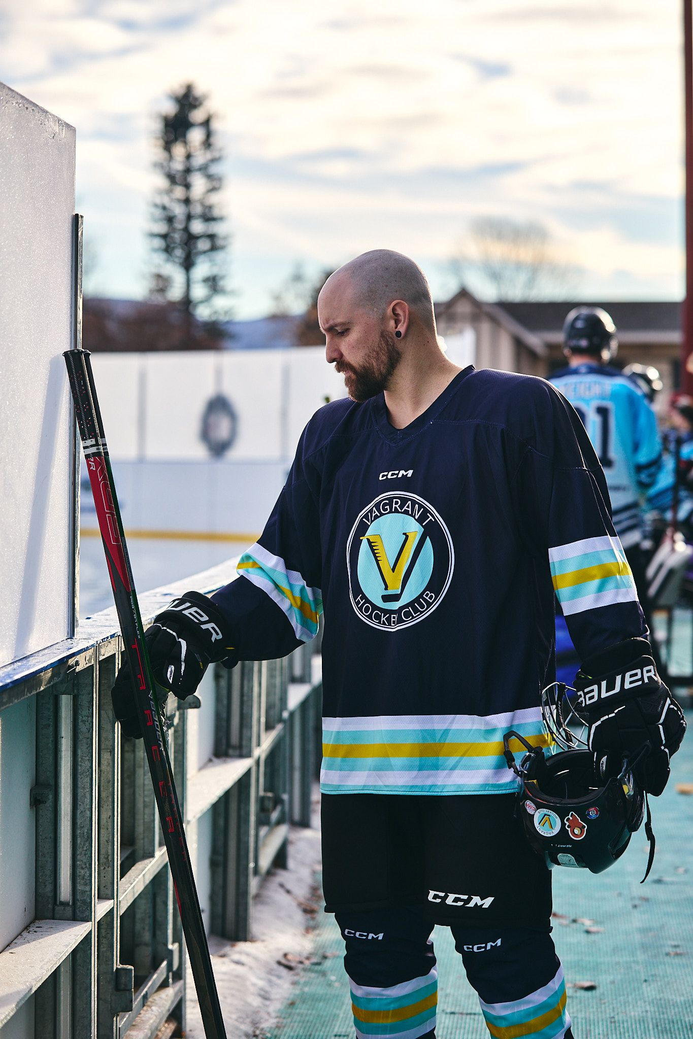 Beer league hockey player picking up a hockey stick during a Utah Rink Rat Society vs Vagrant Hockey Club game.