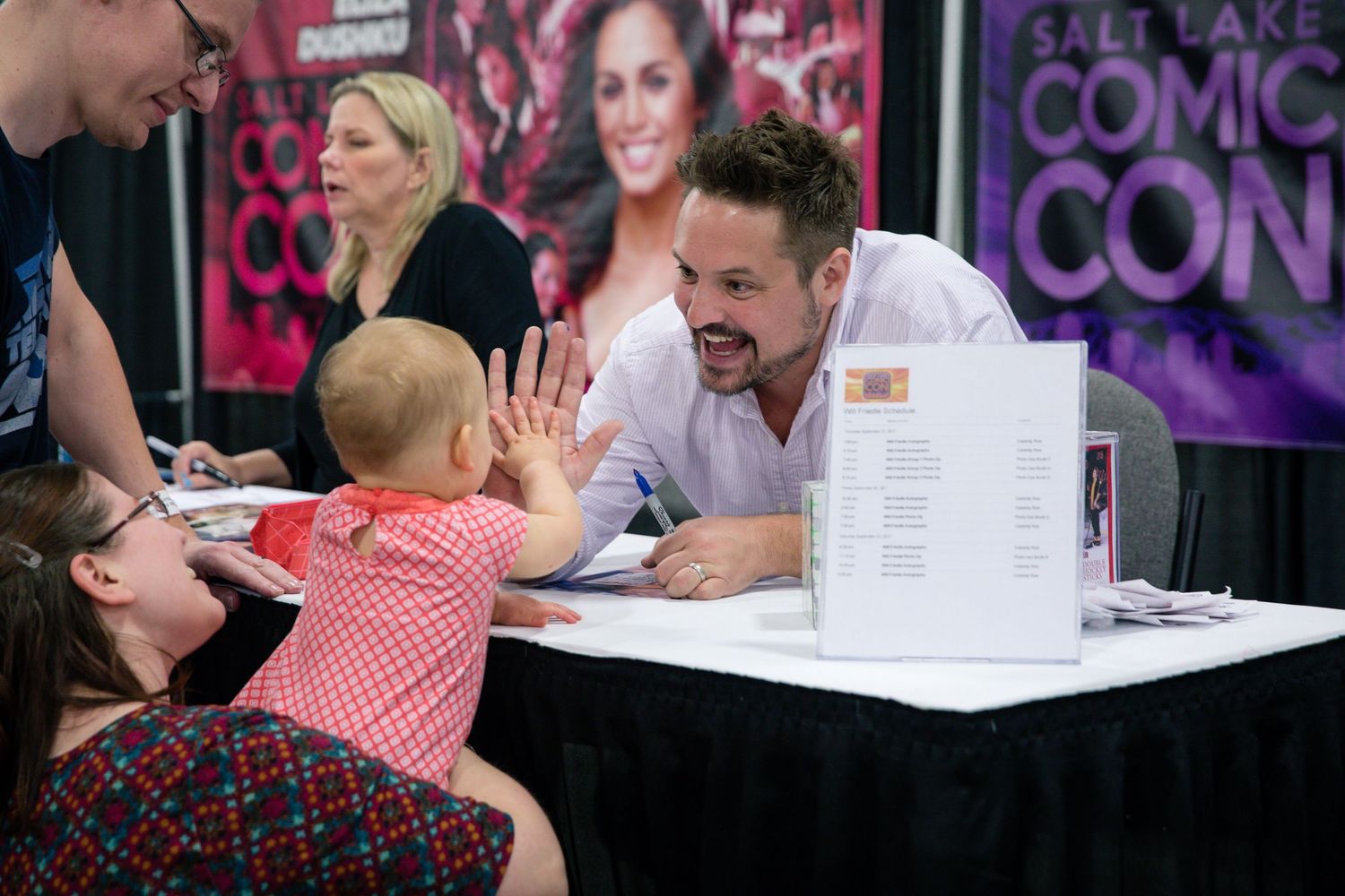 Celebrity guest high fives a cute baby