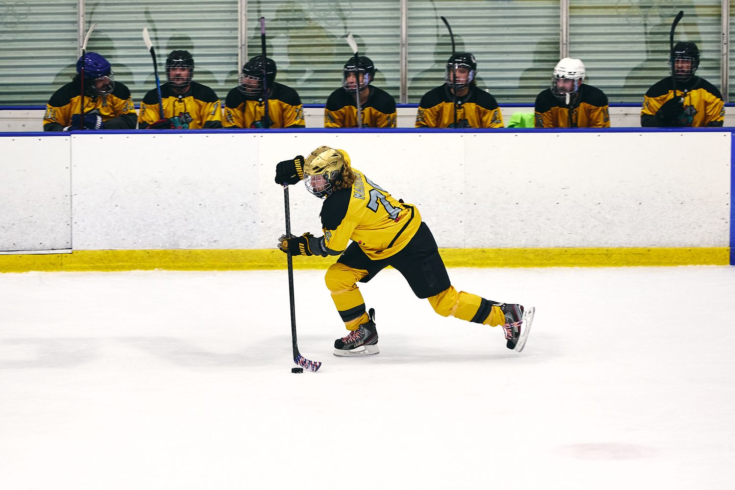 Adult league hockey player moving the puck up the ice