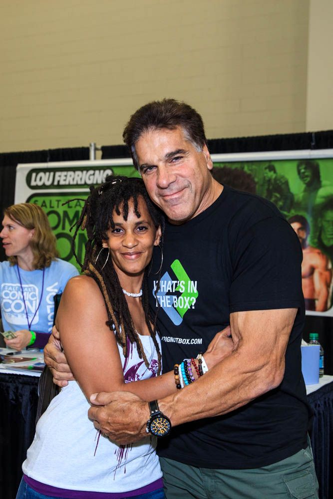 Lou Ferrigno poses hugging a convention guest