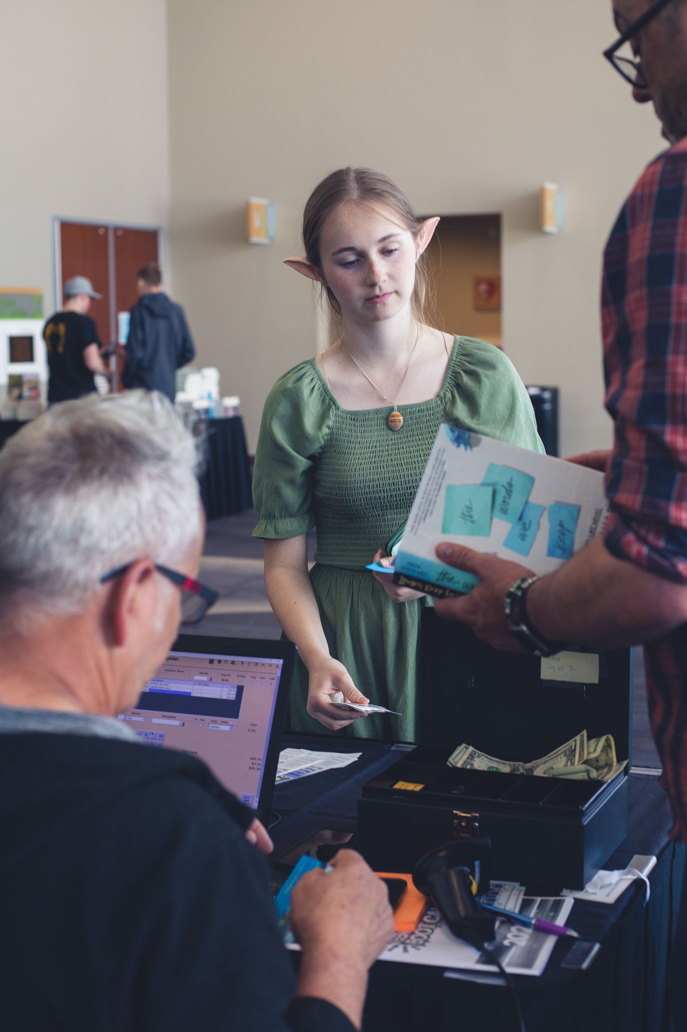 Teen buying books at StoryCon
