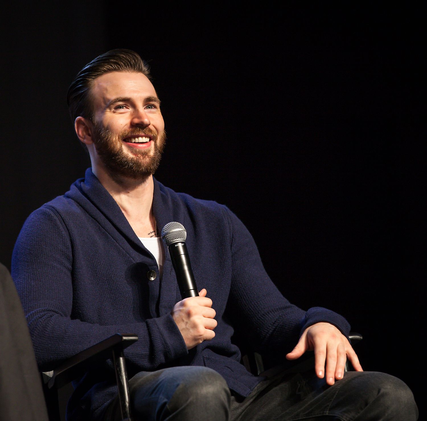 Chris Evans speaking onstage at FanX convention