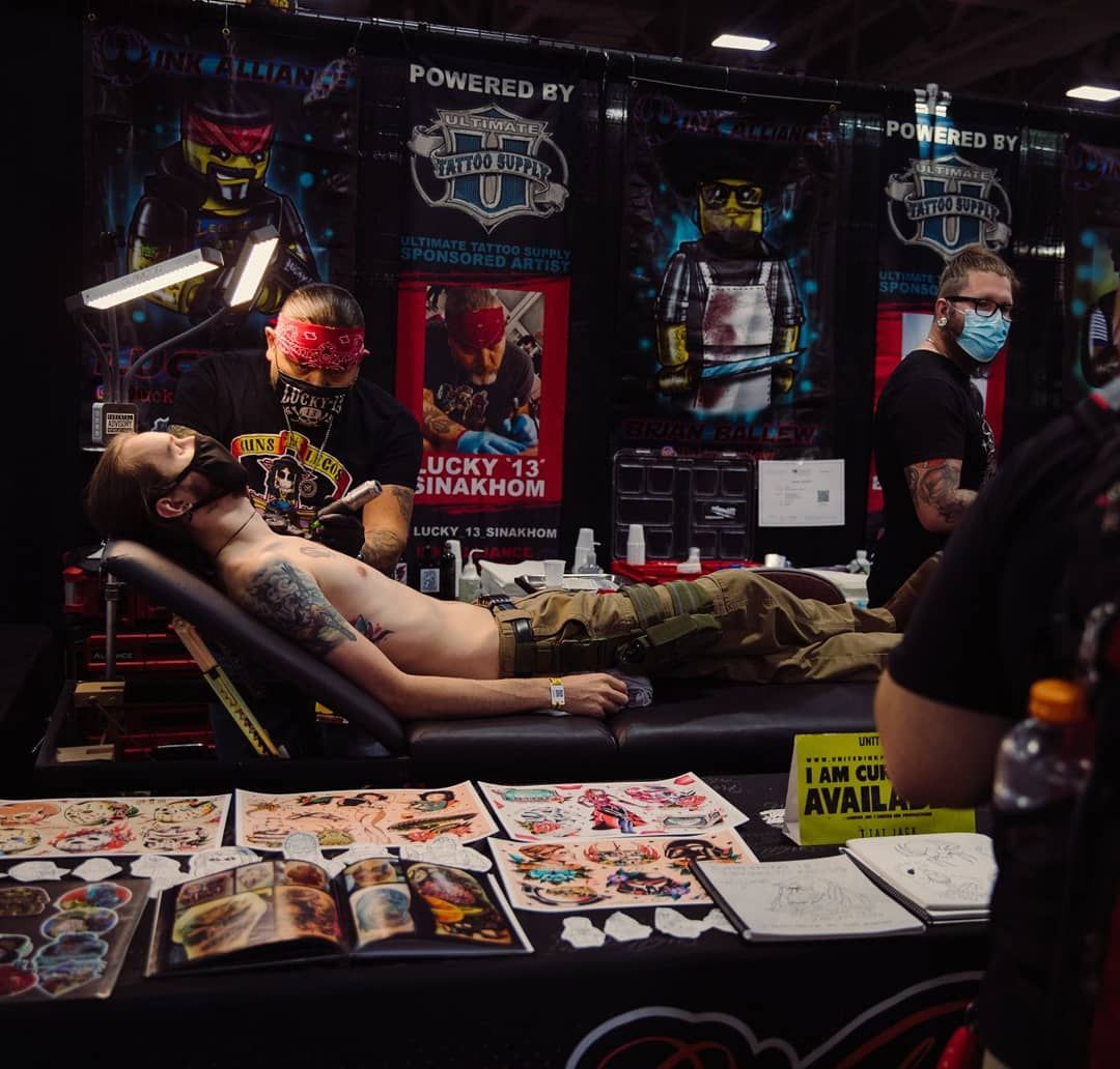 Man getting a tattoo at a convention