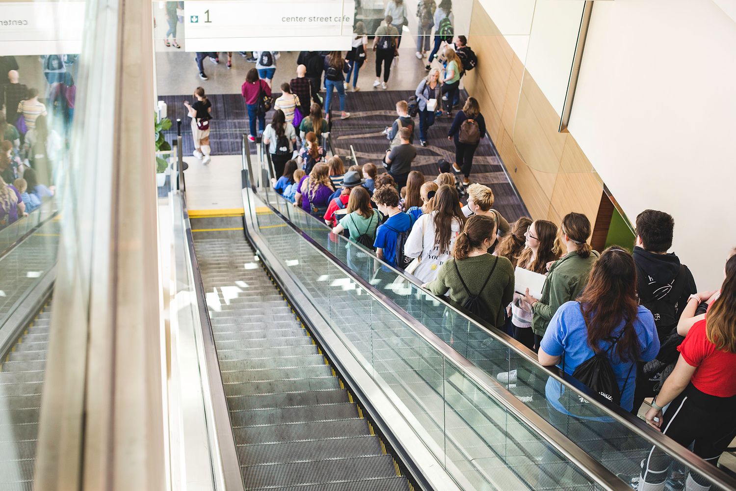 Attendees on the escalator at StoryCon