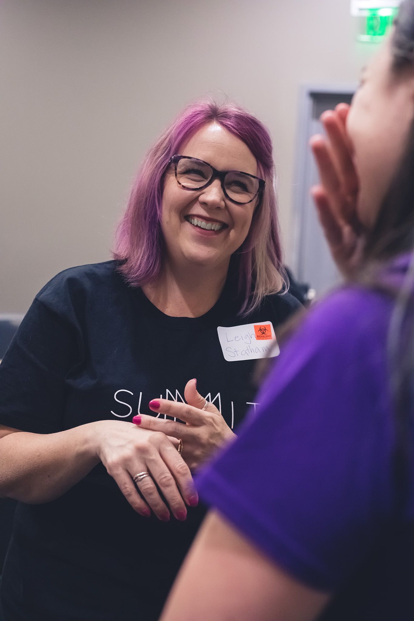 Writer speaking to student during an educational StoryCon event