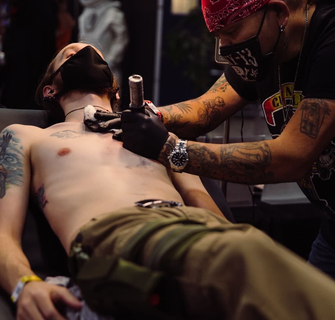 Man getting a tattoo at a convention