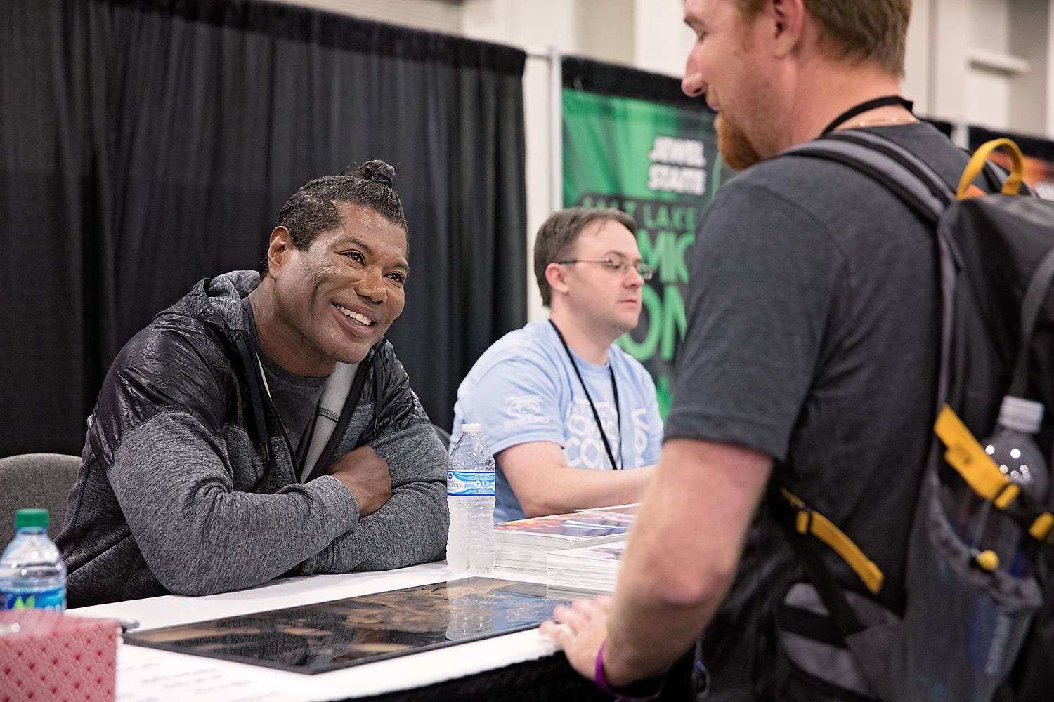 Celebrity guest speaking to a guest at a convention
