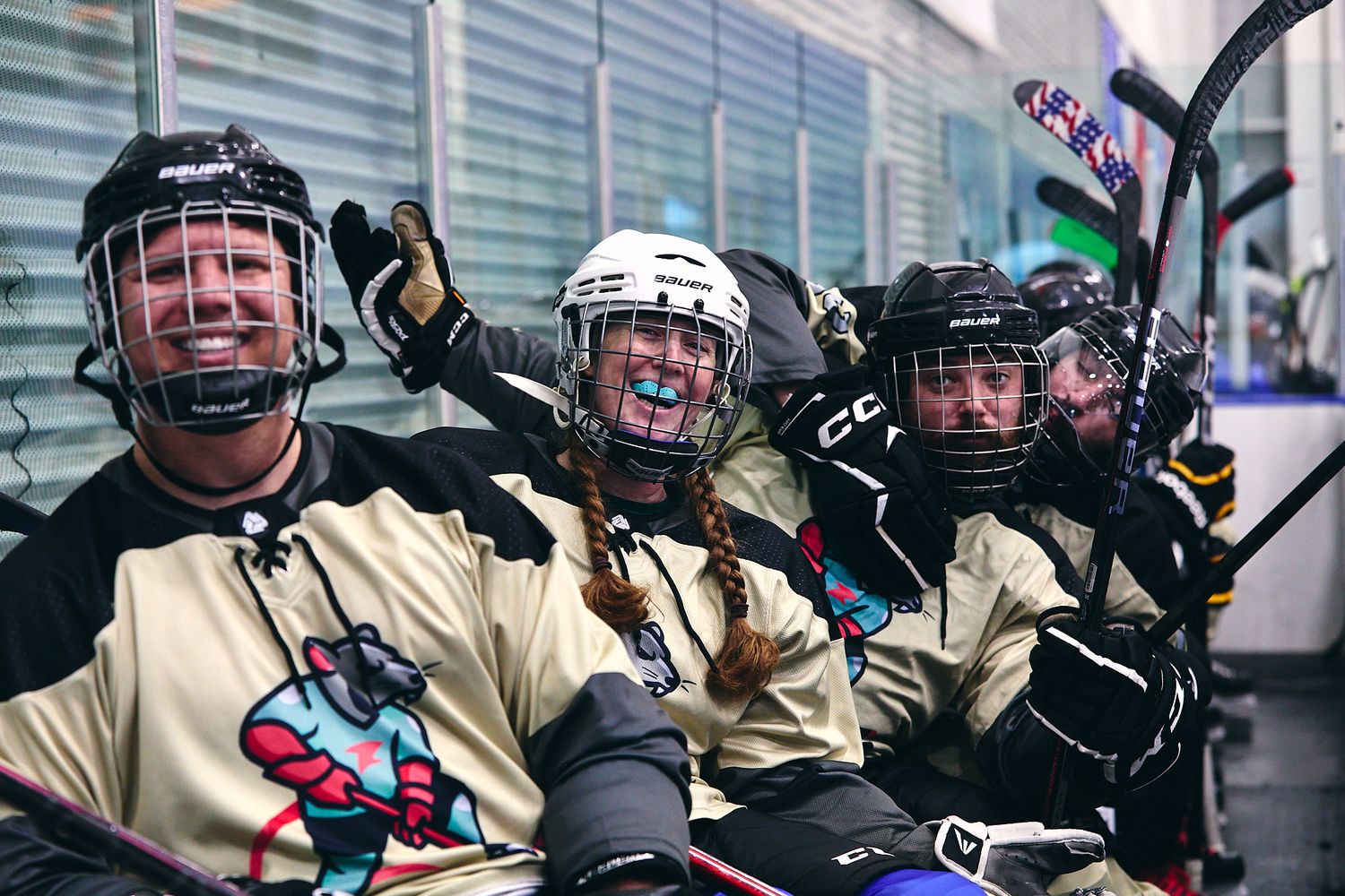 Hockey players smiling and happy on the bench
