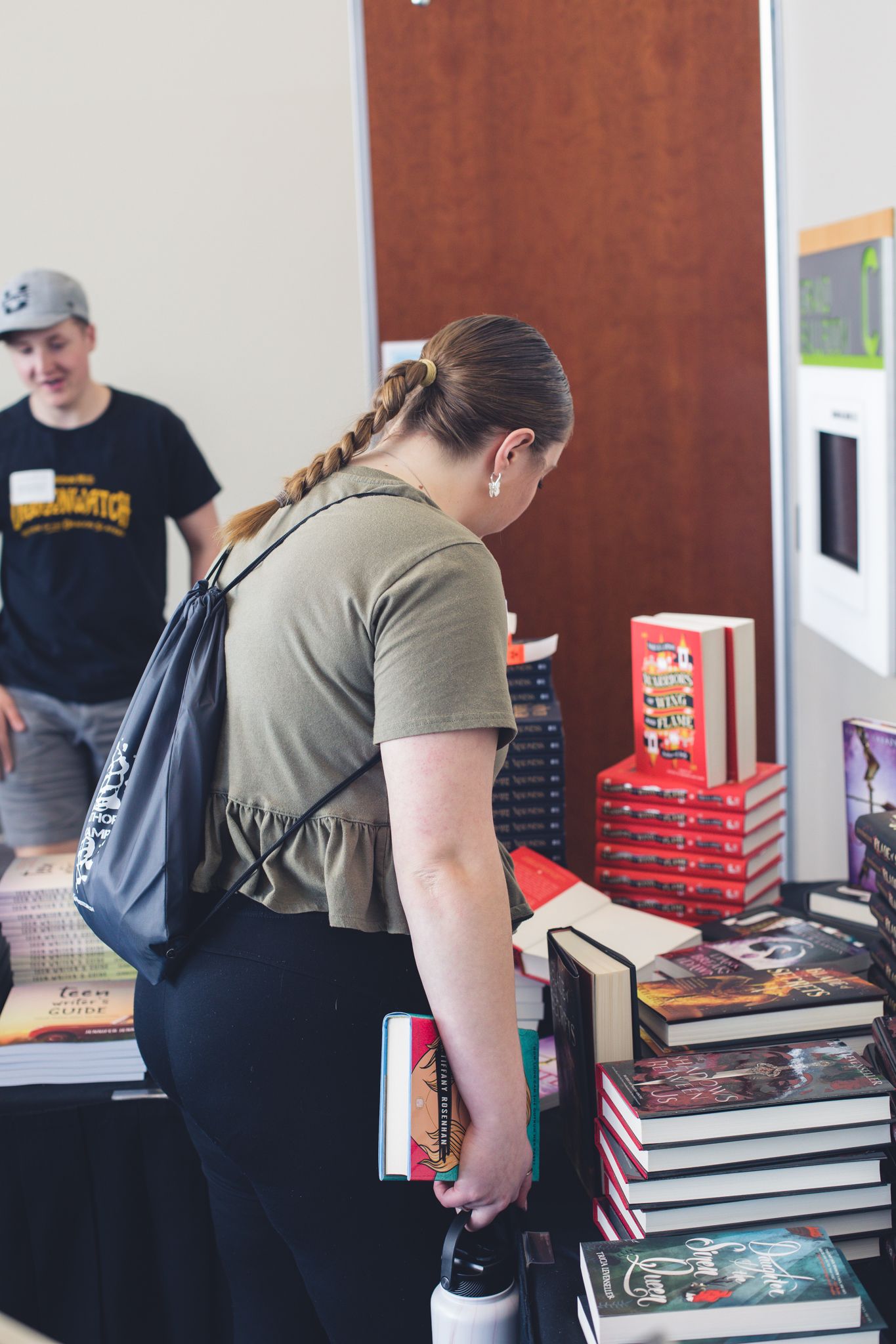 Attendees gathered around books at StoryCon