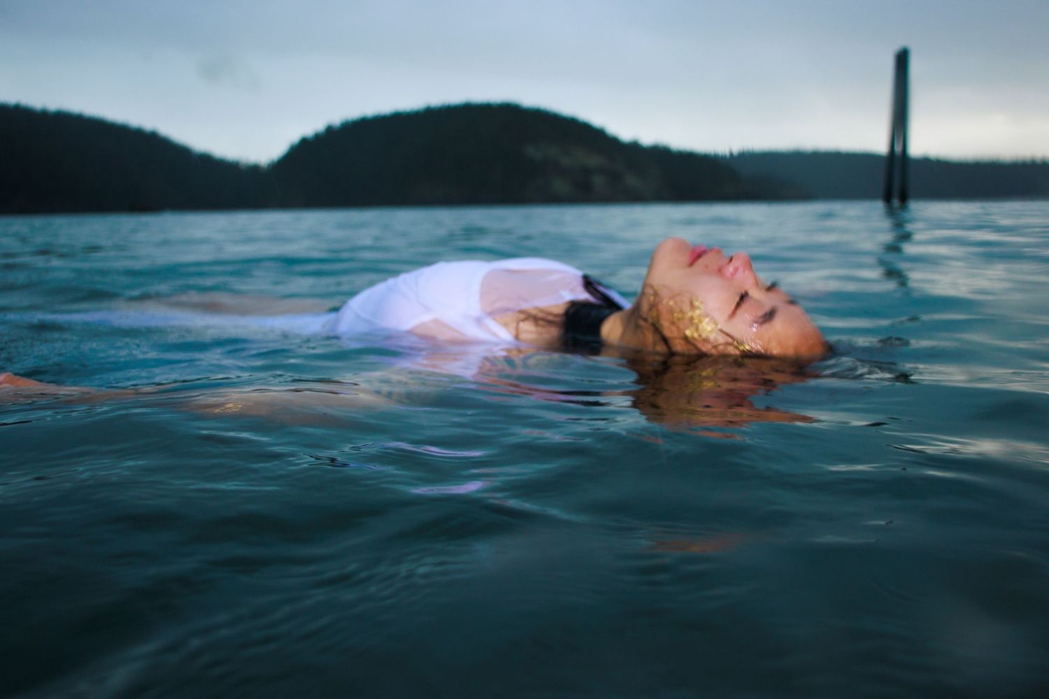 Photo of a woman in a white dress floating in the ocean