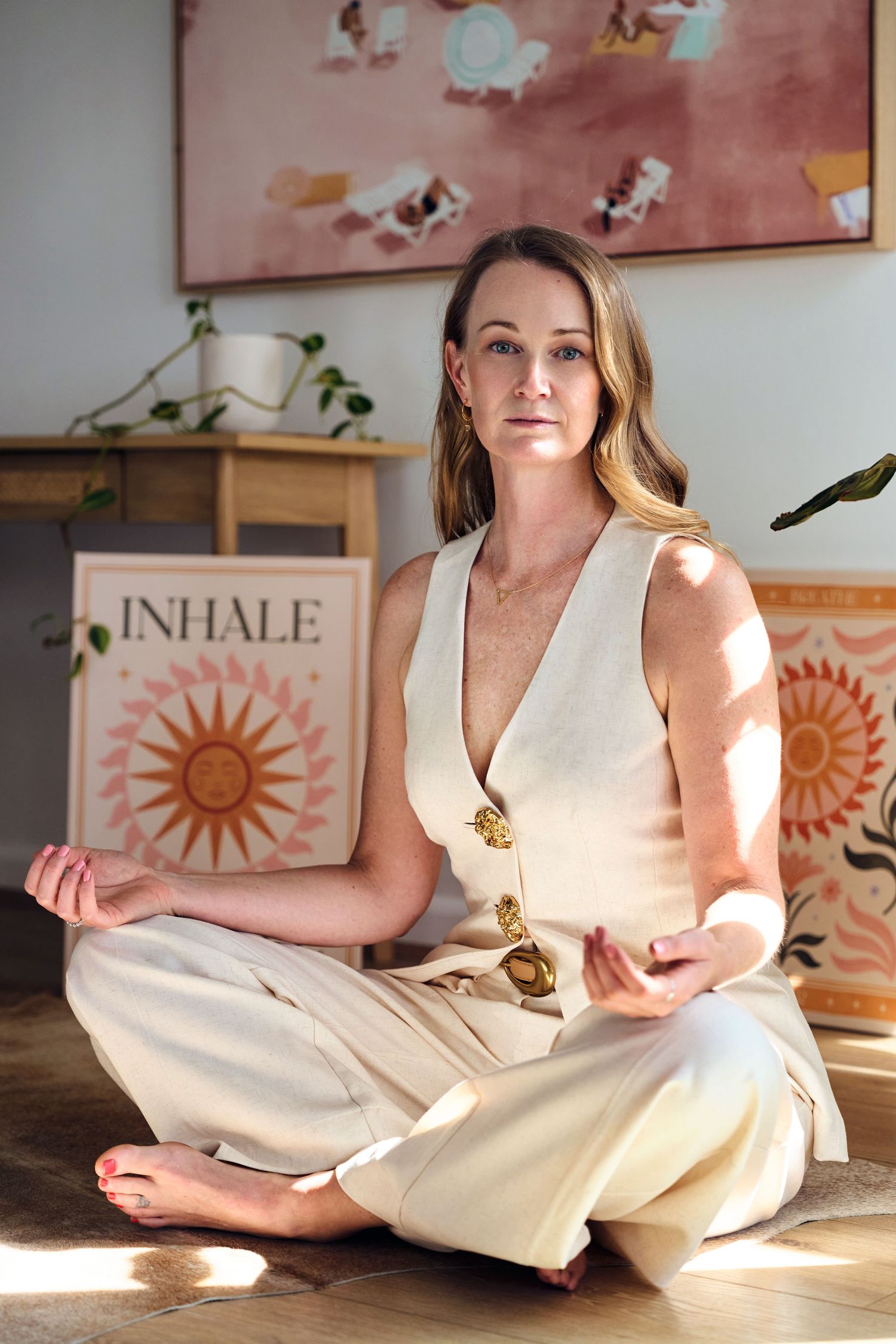 Person sitting in lotus position on floor with sunlit yoga studio for a lifestyle business shoot by Studio TingTing in Sydney