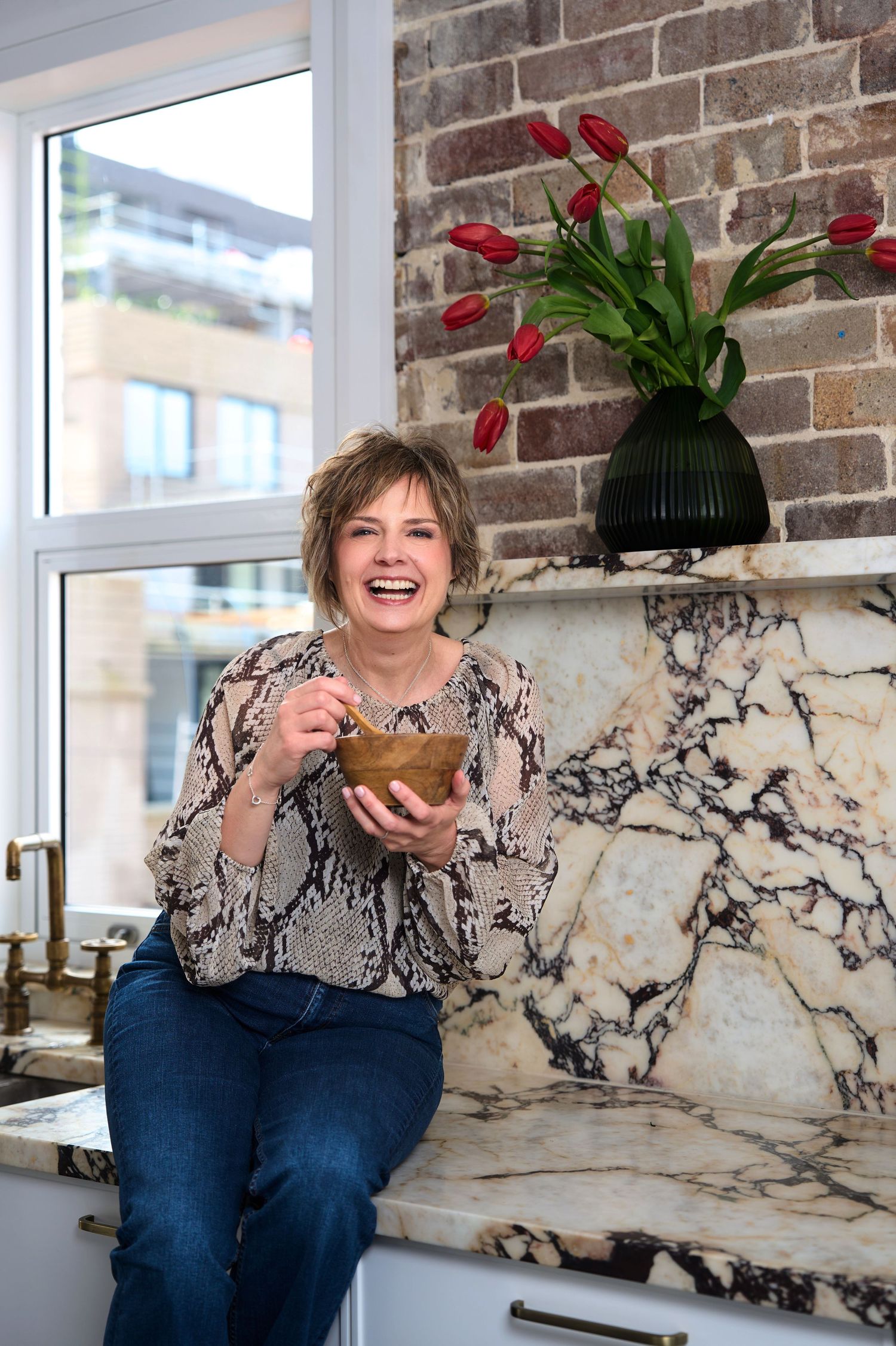 Casual lifestyle photos in kitchen for a nutritionist posing for personal branding photos in Sydney by Studio TingTing.