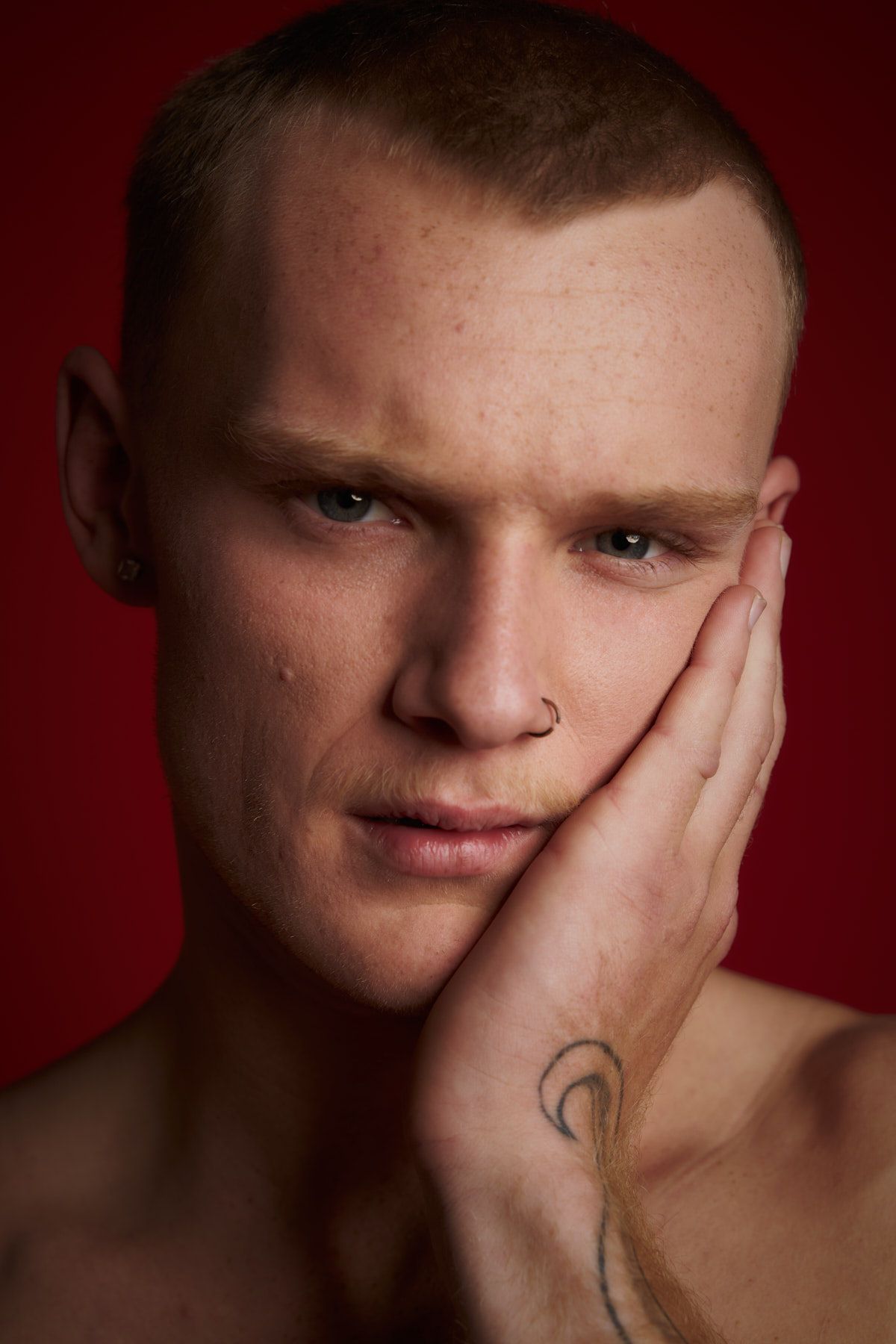Close-up portrait against red background with hand covering part of face — business branding photography Sydney — Studio TingTing