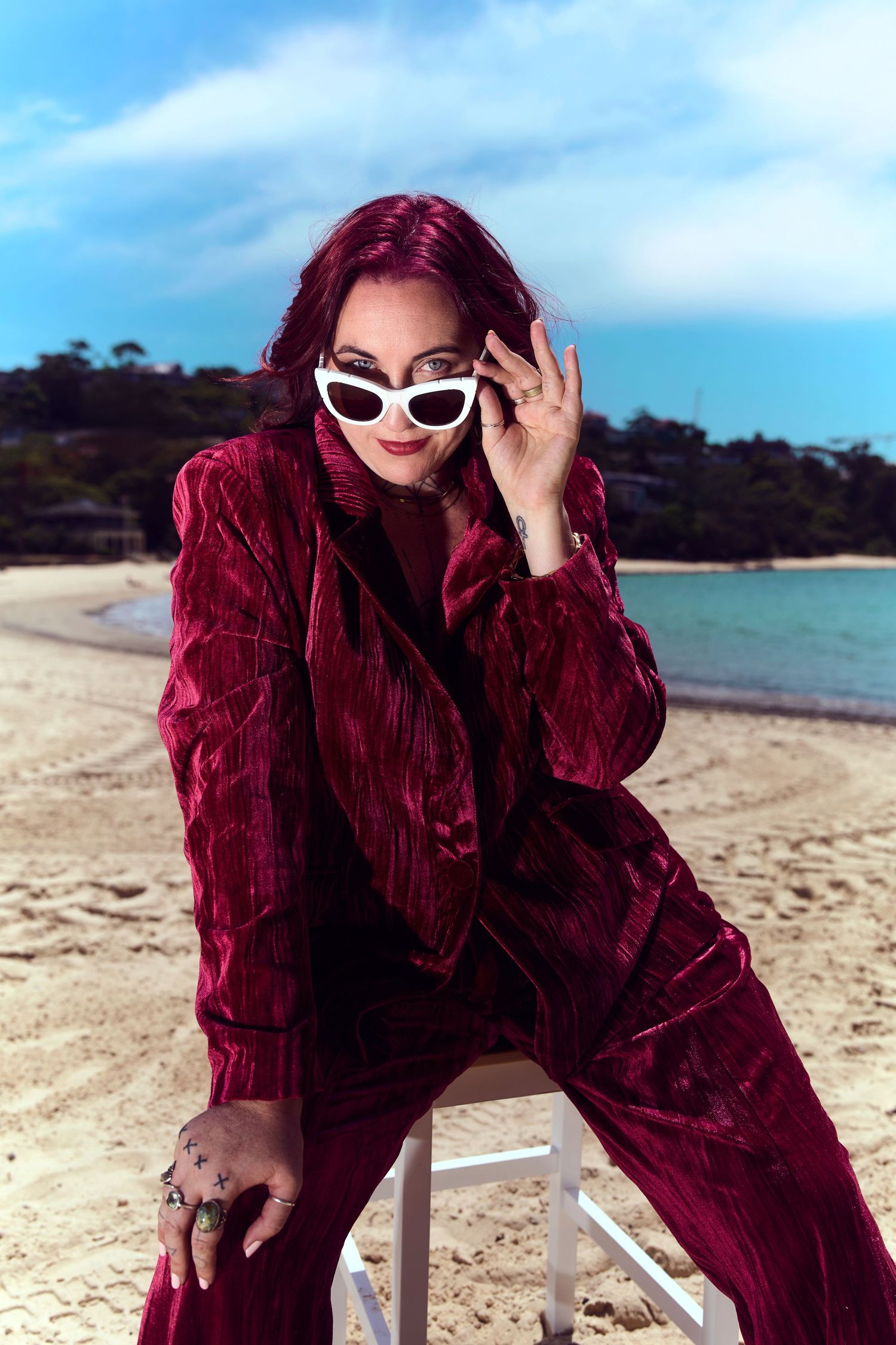 A business mystic posing against a scenic coastal backdrop shot by Sydney personal branding photographer Tammy TingTing.