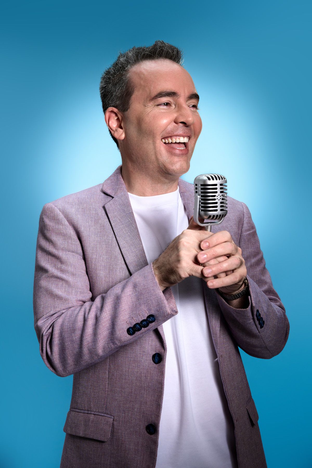Portrait of coach holding microphone for podcast, shot by Sydney personal branding photographer Tammy TingTing.