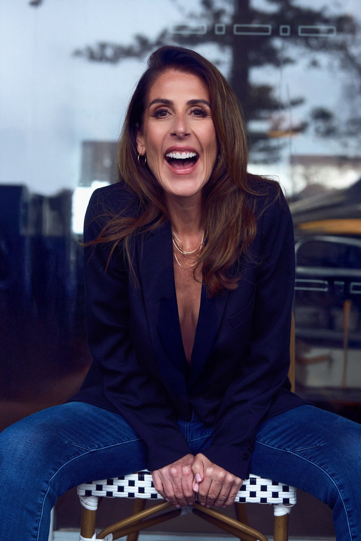 Mature woman laughing during outdoor professional photoshoot series for dating profile in Dee Why. By Studio TingTing in Sydney.