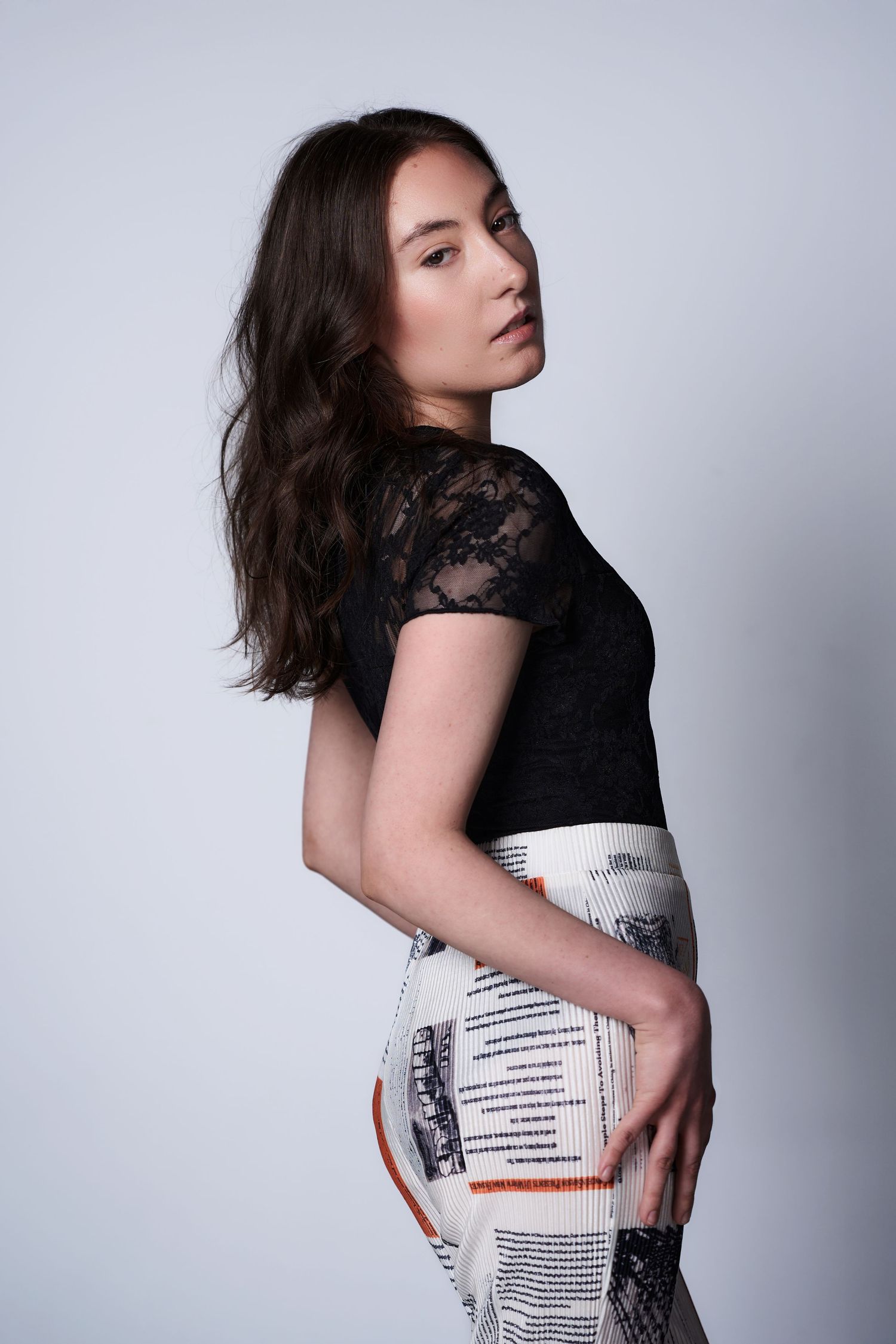 Fashion model poses in black lace top and printed pants against gray backdrop in artistic portrait series Sydney - Studio TingTing