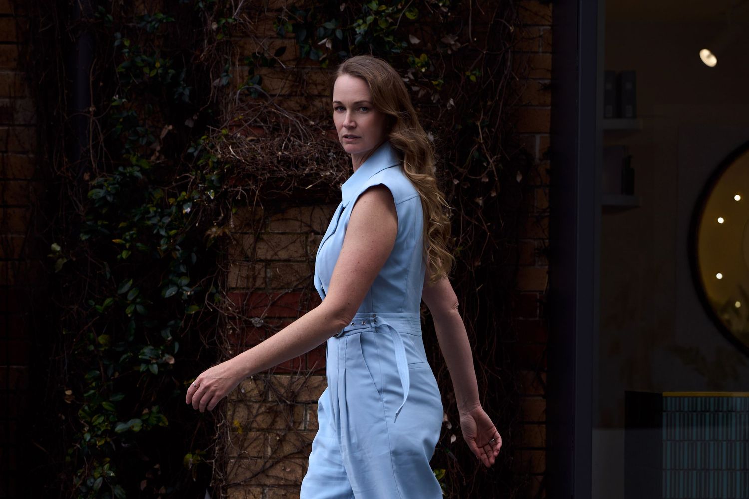 A female founder posing on Cronulla street, shot by Sydney personal branding photographer Tammy TingTing.