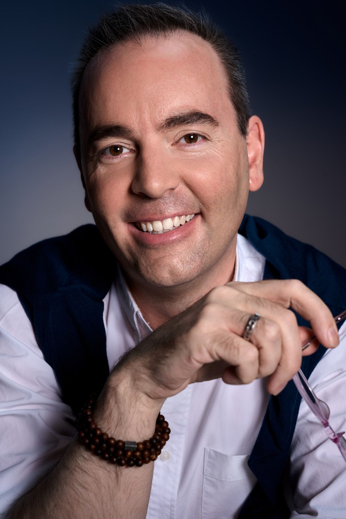 Branding Professional headshot of a coach in a white shirt and navy vest smiling warmly in sydney studio by Studio TingTing.