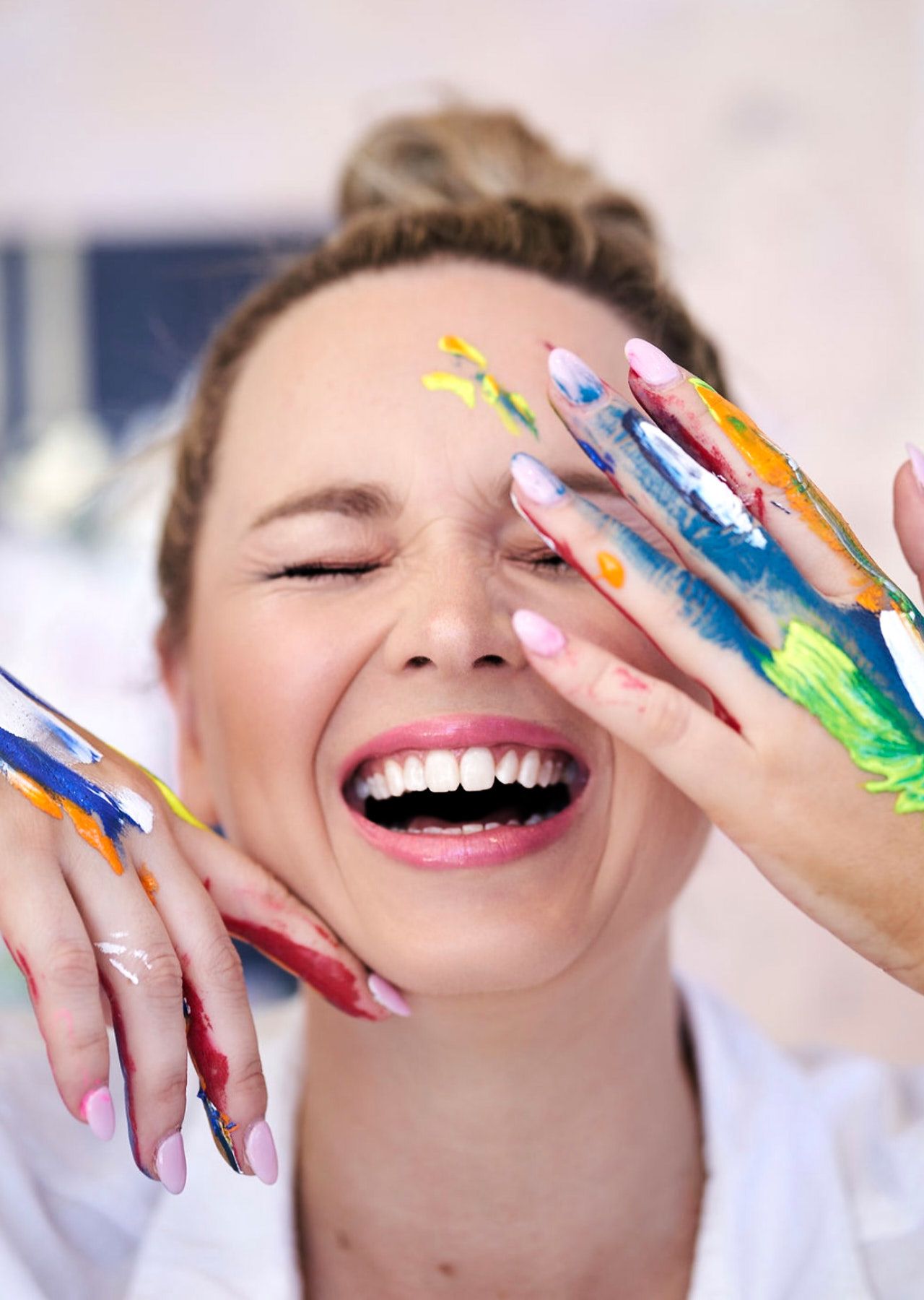 A Sydney creative showing colorful paint-covered hands and joyful expressions her personal branding session by Studio TingTing.