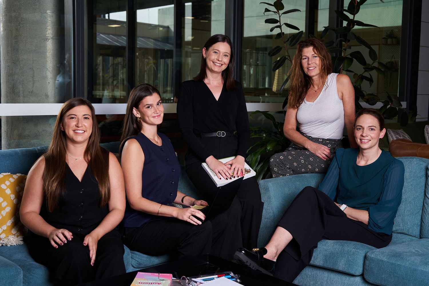 Modern editorial corporate photography Sydney finance firm team photoshoot on blue sofa. Shot by Sydney professional photographer Tammy.