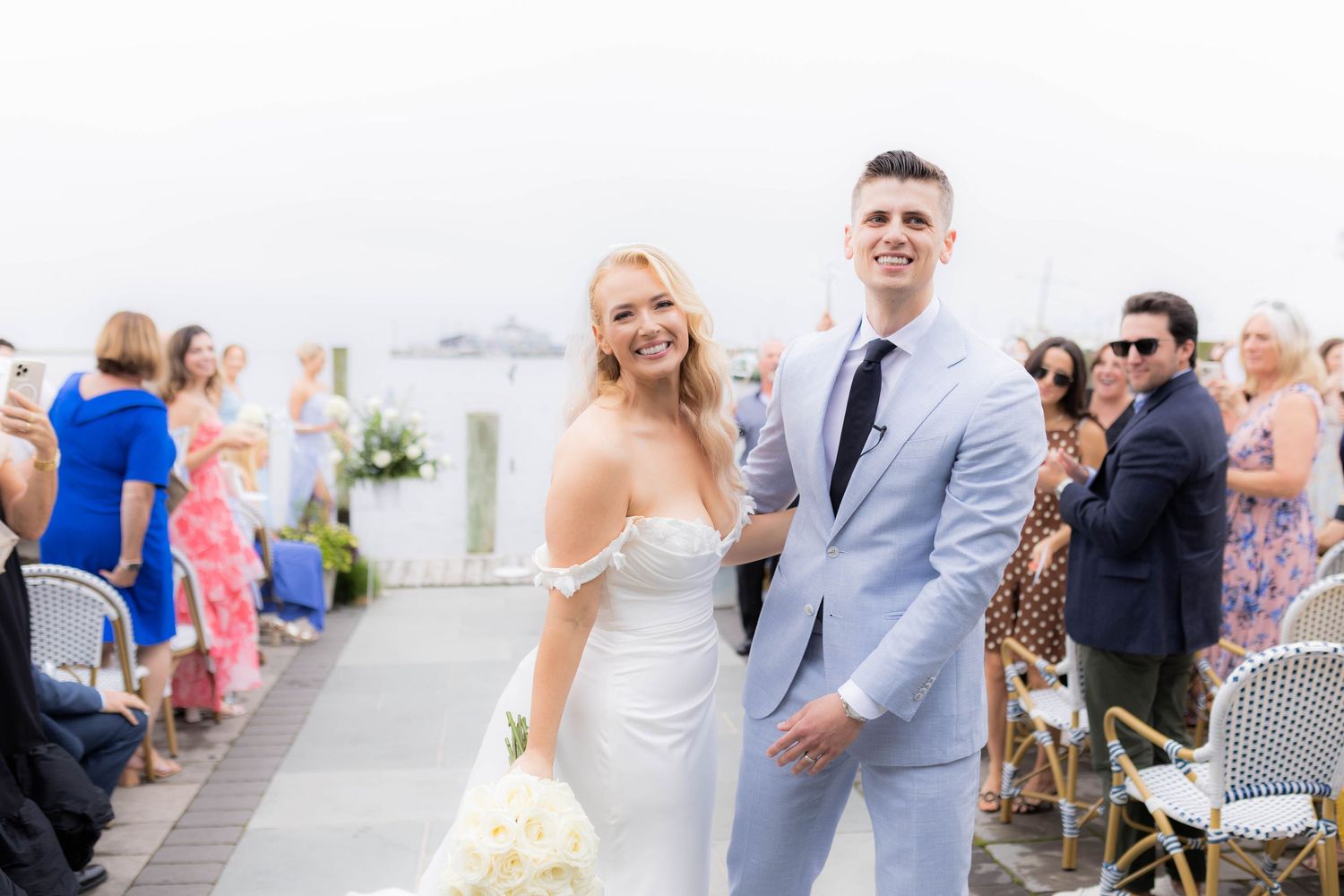 A series of wedding photos showing couples and guests celebrating at an outdoor reception by the water.
