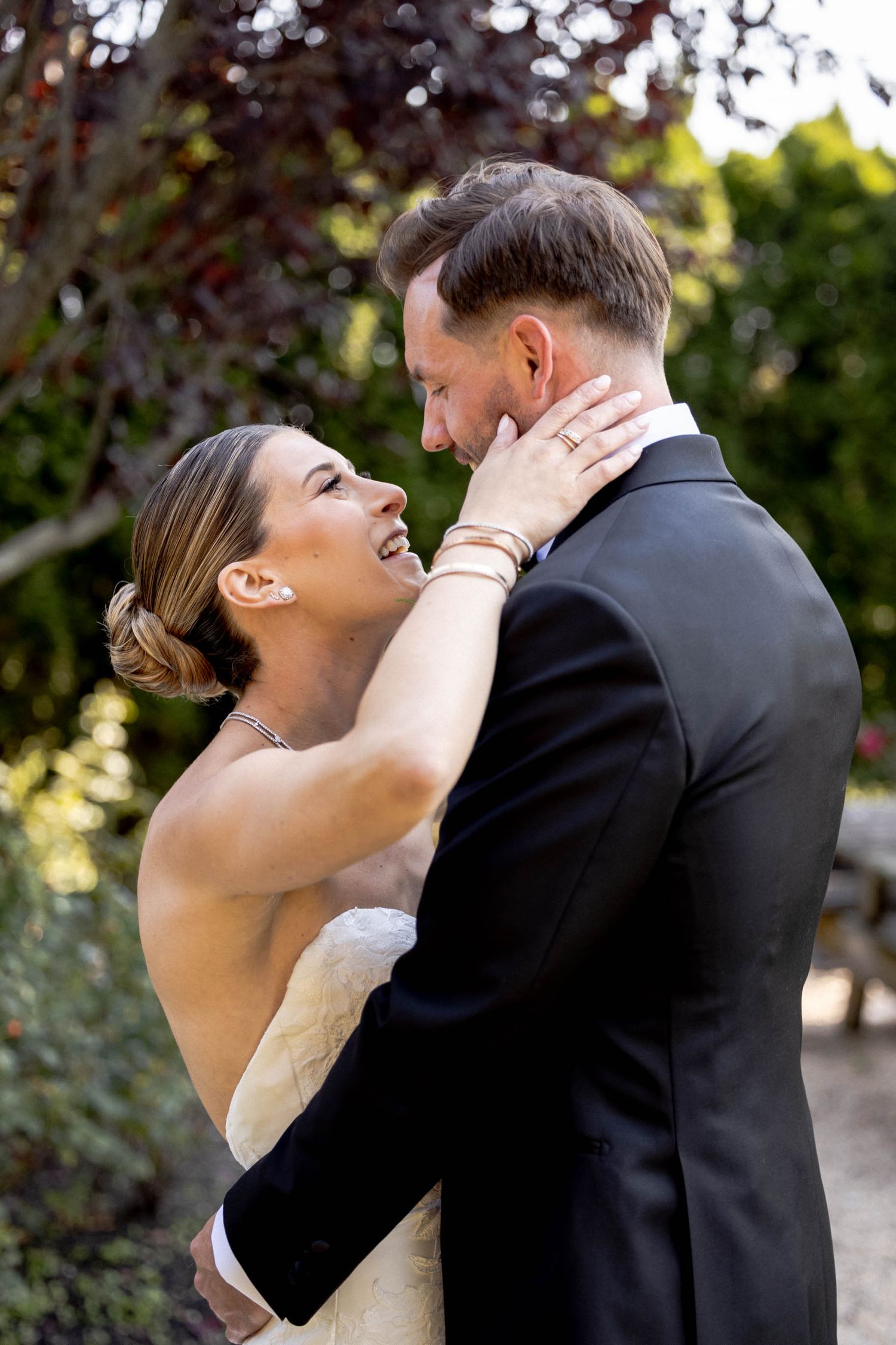 A romantic sequence of wedding photos shows a couple sharing their first look and intimate embrace in an outdoor garden setting.
