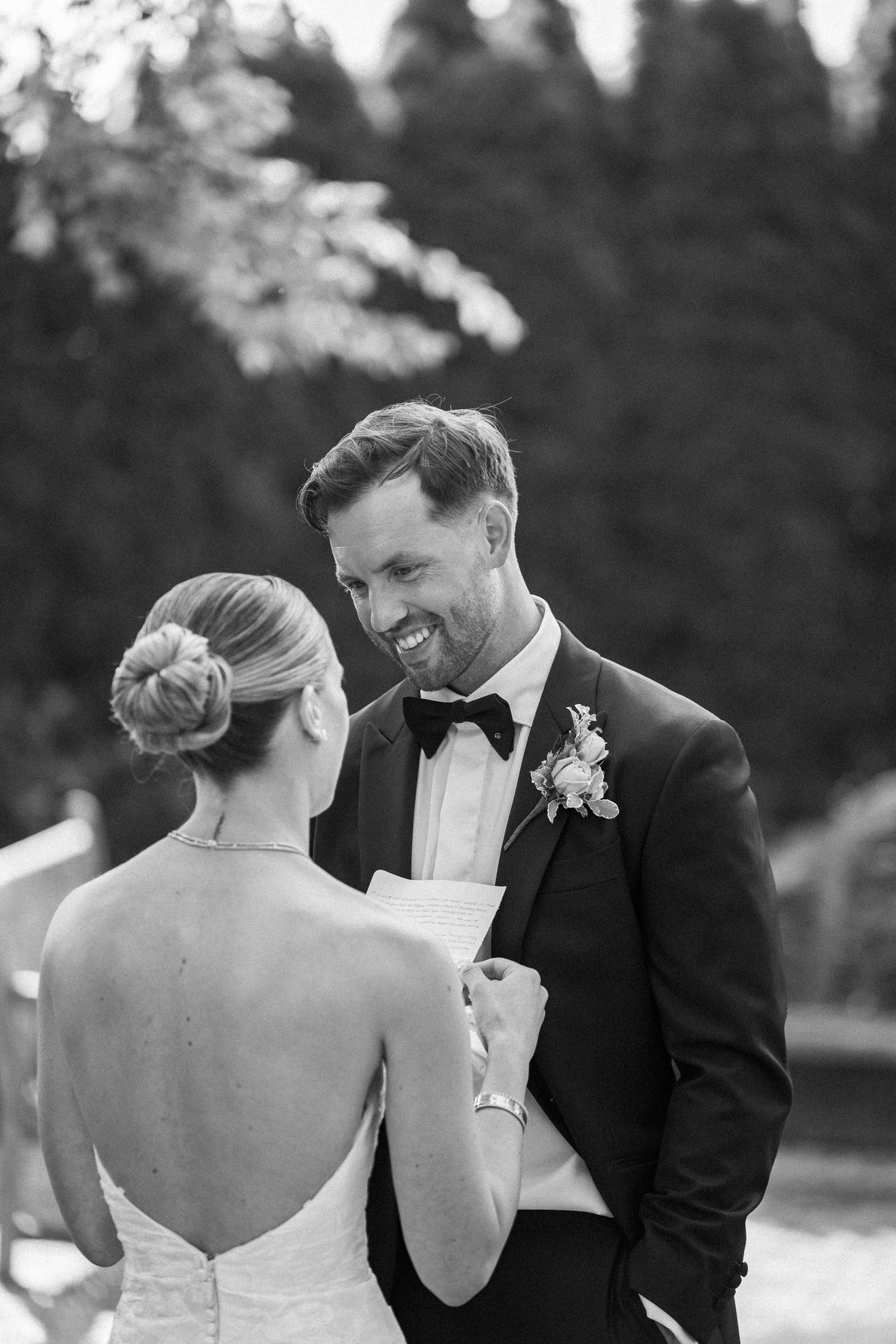 A black and white photo series capturing joyful moments during a wedding dance outdoors.