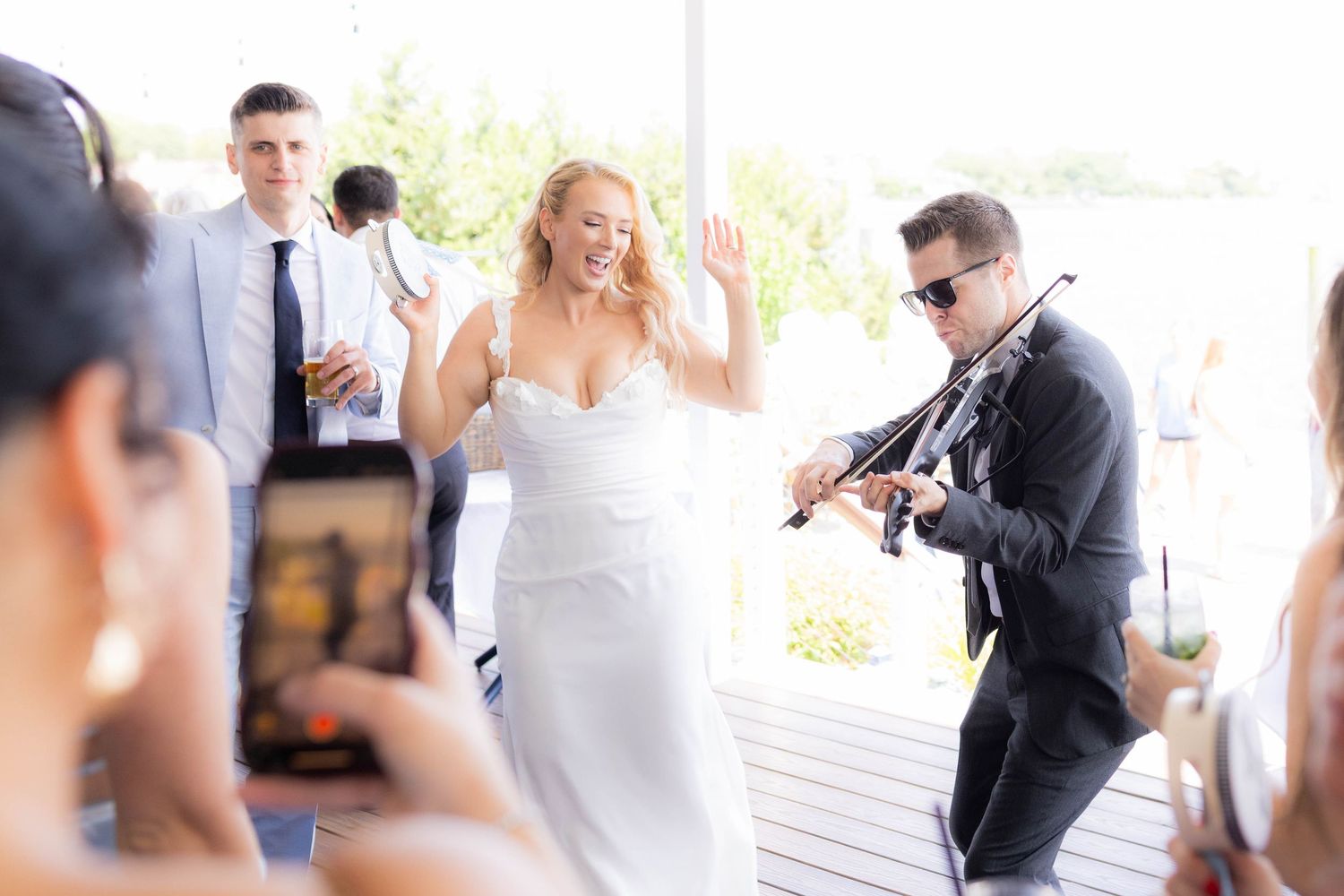 Wedding party getting ready and sharing candid moments during preparations at a bright indoor venue.