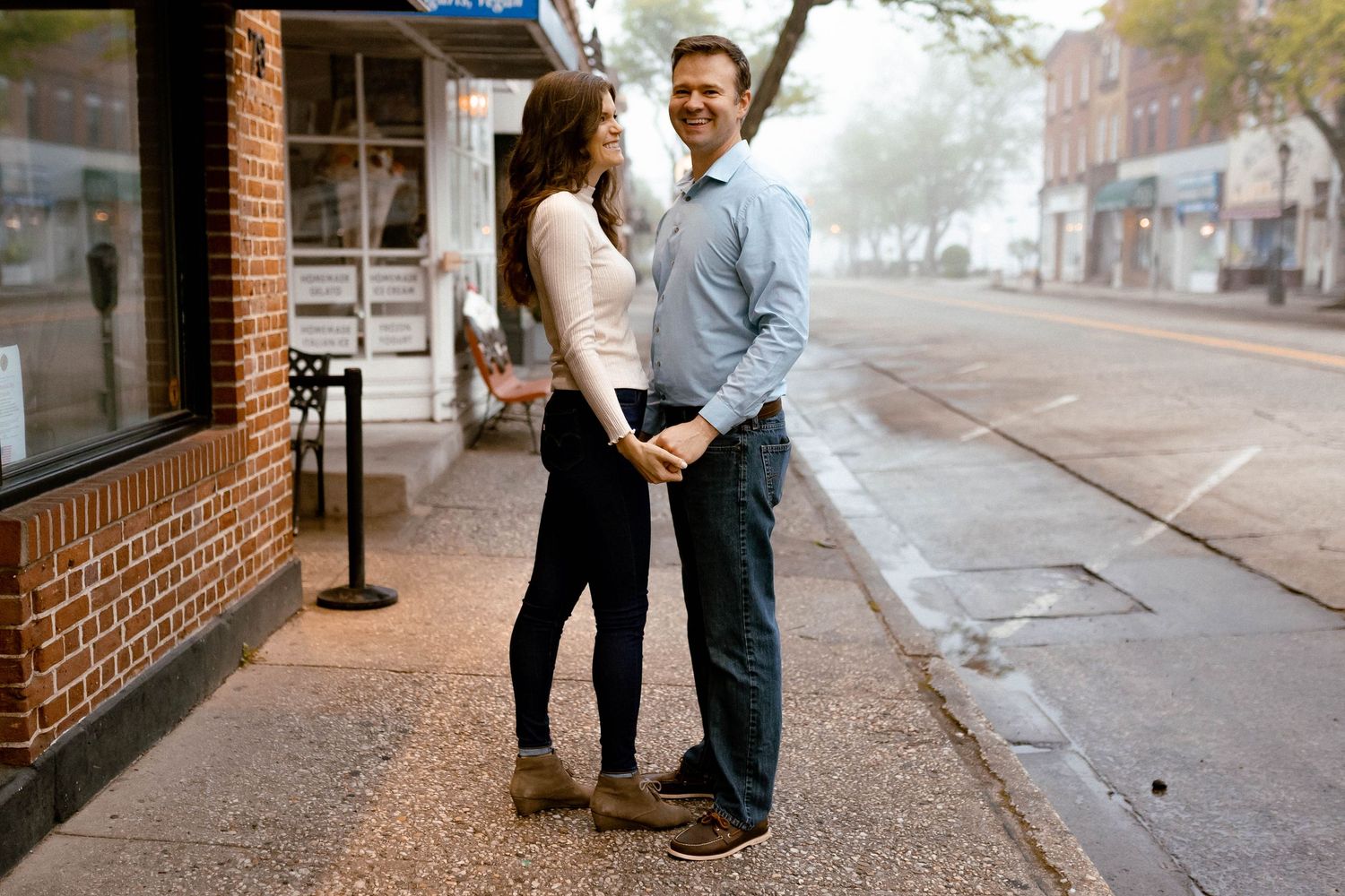 A couple shares a romantic moment on a brick-lined street in the historic Northport district.