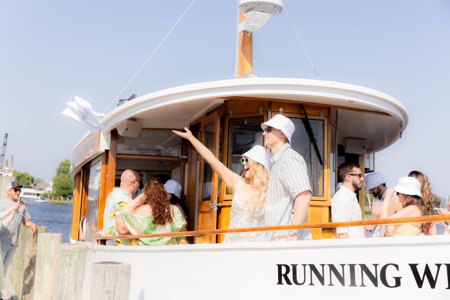 Passengers relaxing on the deck of boat 'Running Wild' during a daytime cruise.