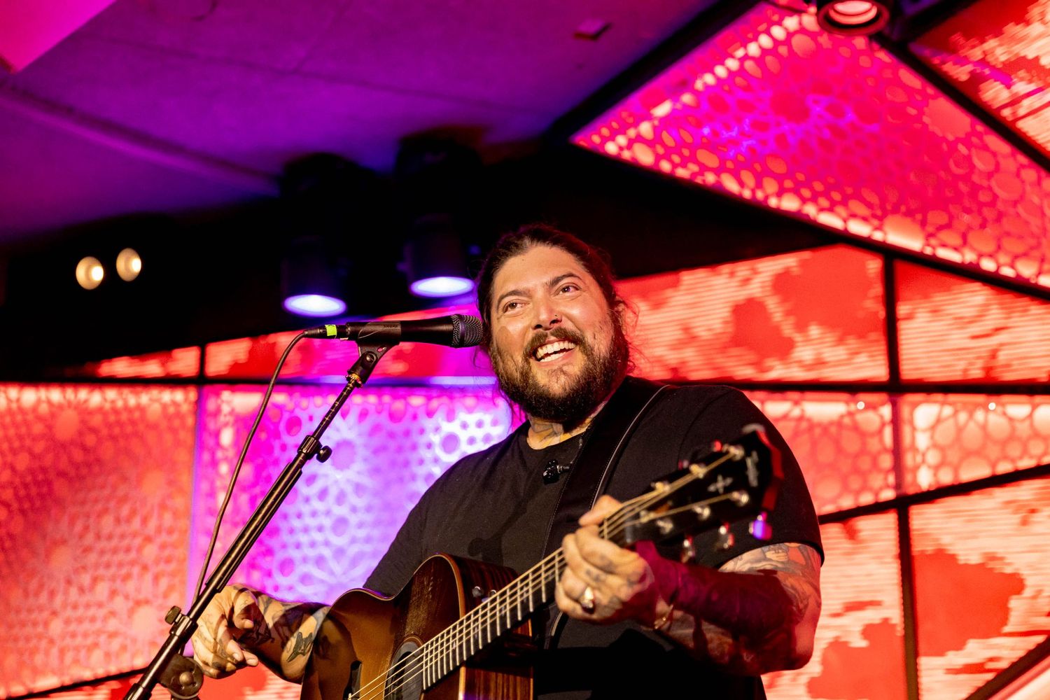 Musicians perform under vibrant red and purple stage lighting with dramatic visual effects. Amigo the Devil by Fireside Sparrow in Brooklyn