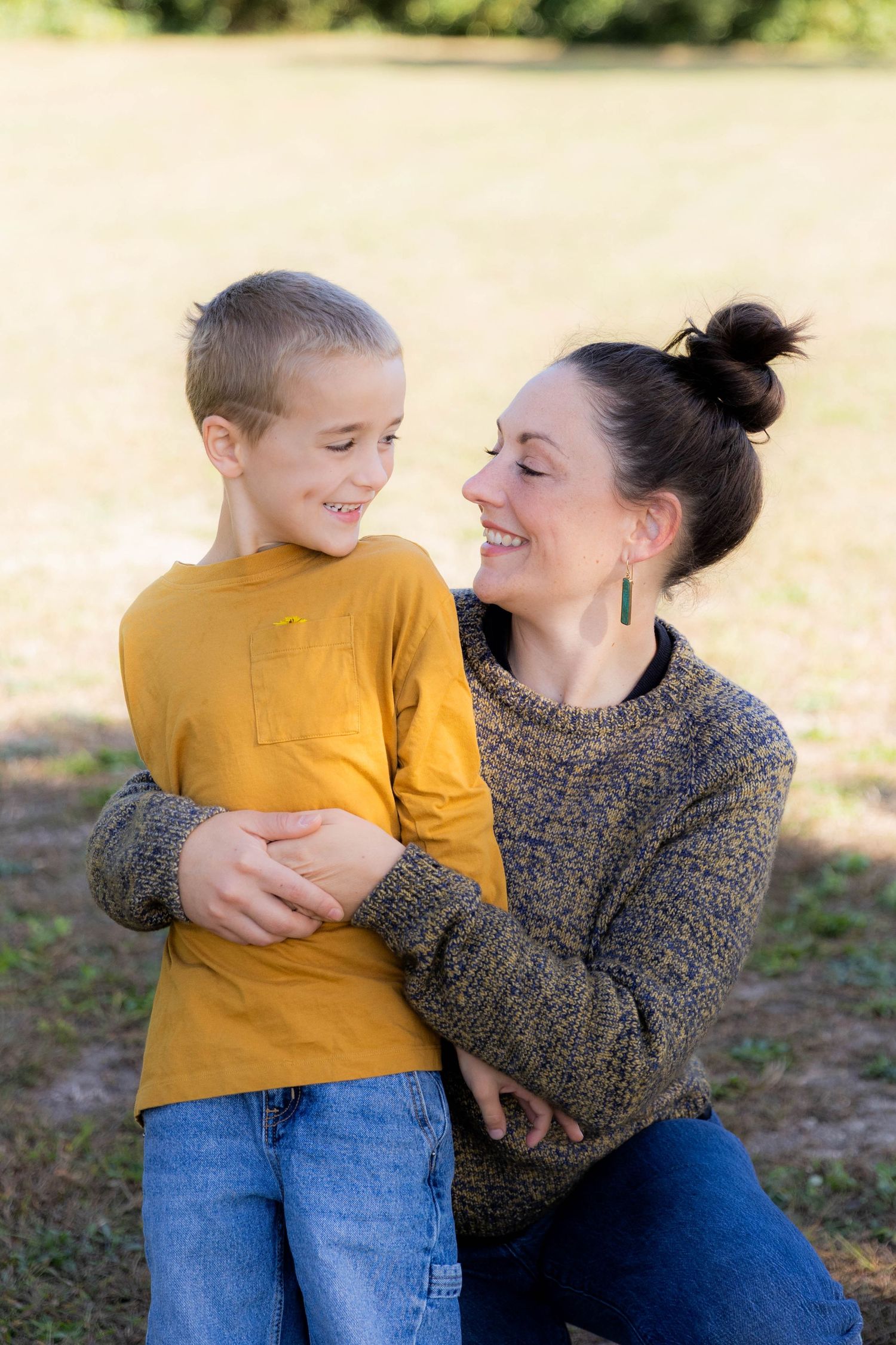 A tender moment captured between two people in casual wear outdoors. Fireside Sparrow Photography
