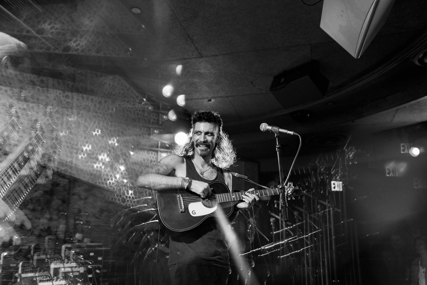 Wide angle panoramic view of musicians performing on dimly lit stage with instruments. Brooklyn, the Sultan's Room by Fireside Sparrow