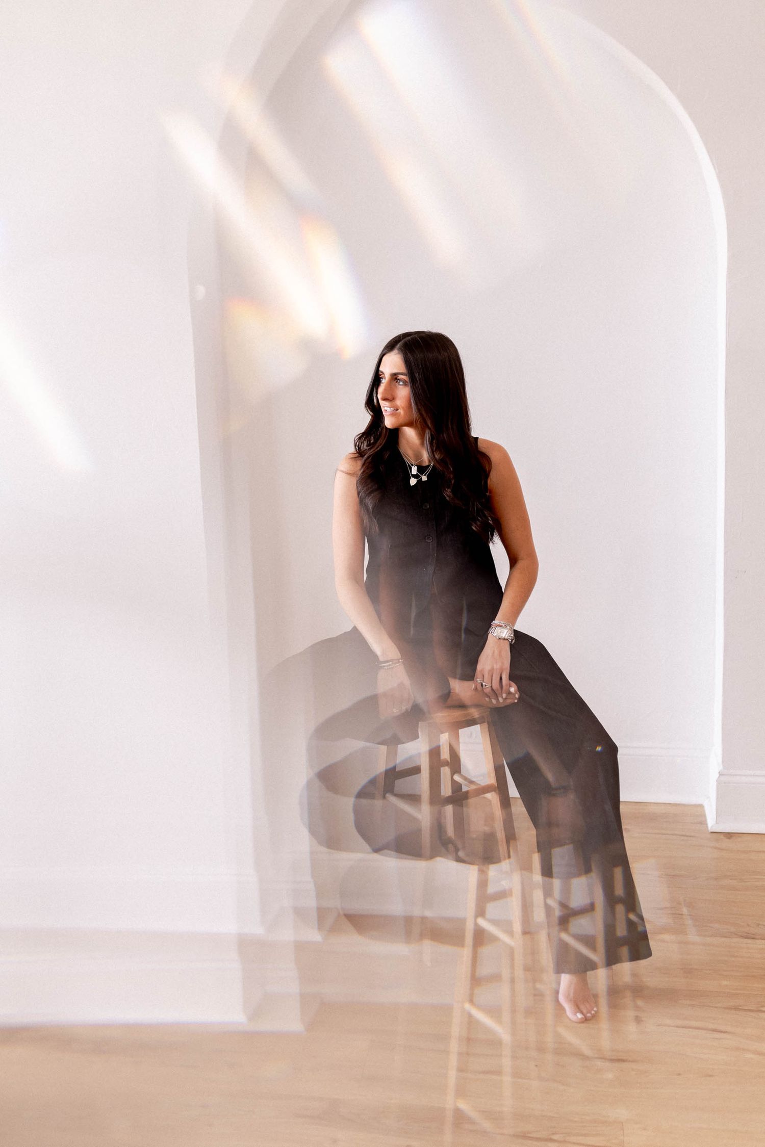 Artistic photo sequence showing movement and shadows on a wooden floor with white walls.