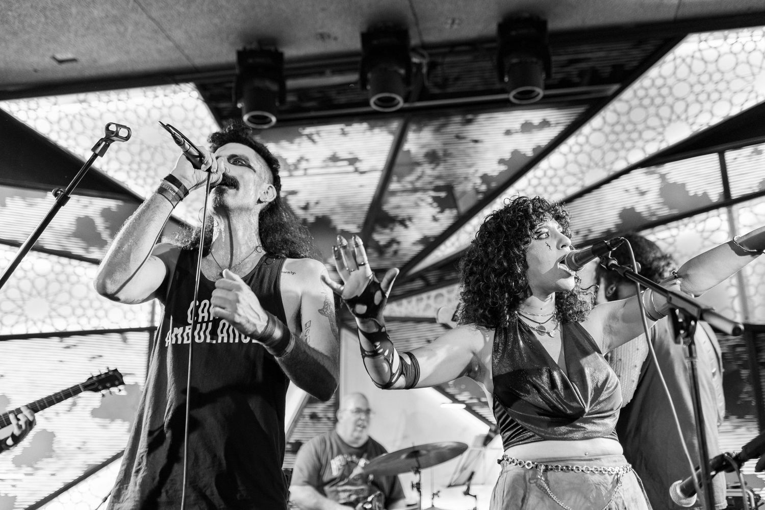 Black and white wide shot of band members performing energetically on stage. Brooklyn, the Sultan's Room by Fireside Sparrow