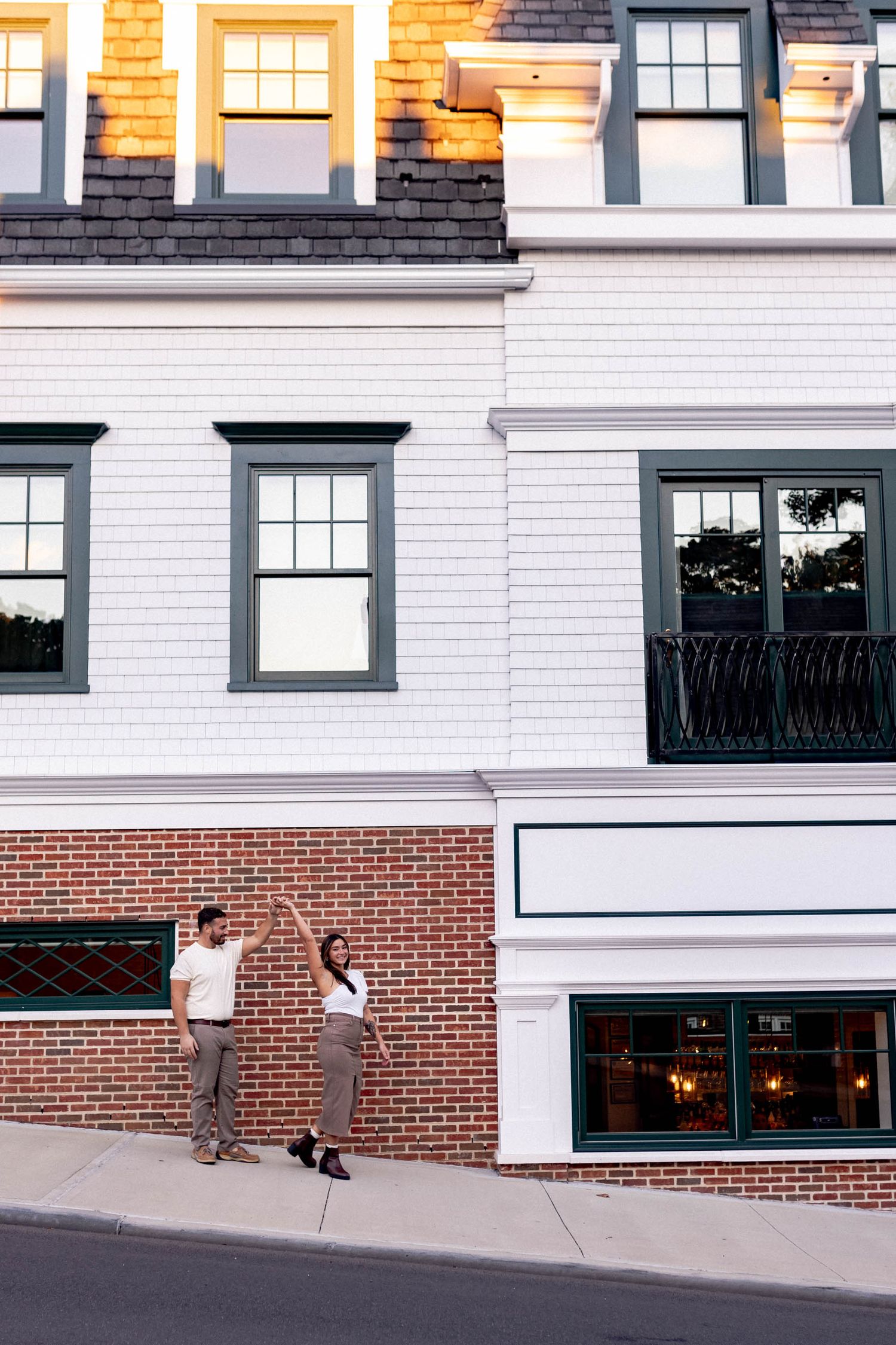 Modern brick and white commercial building exterior with large windows and architectural details.