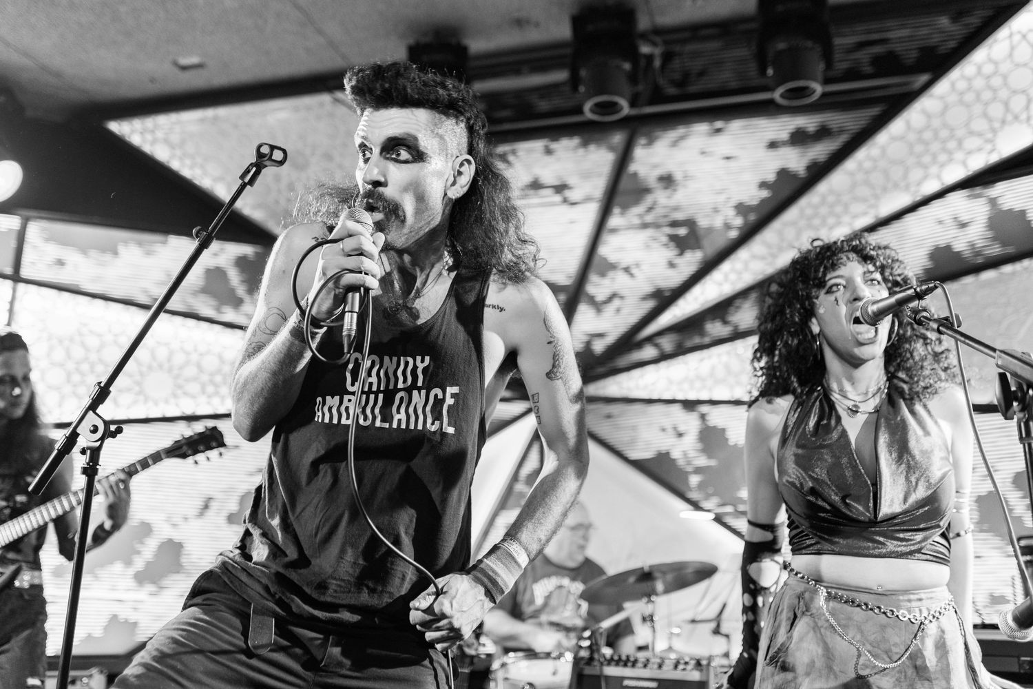 Dynamic black and white performance shots showing musicians on stage during a live show.